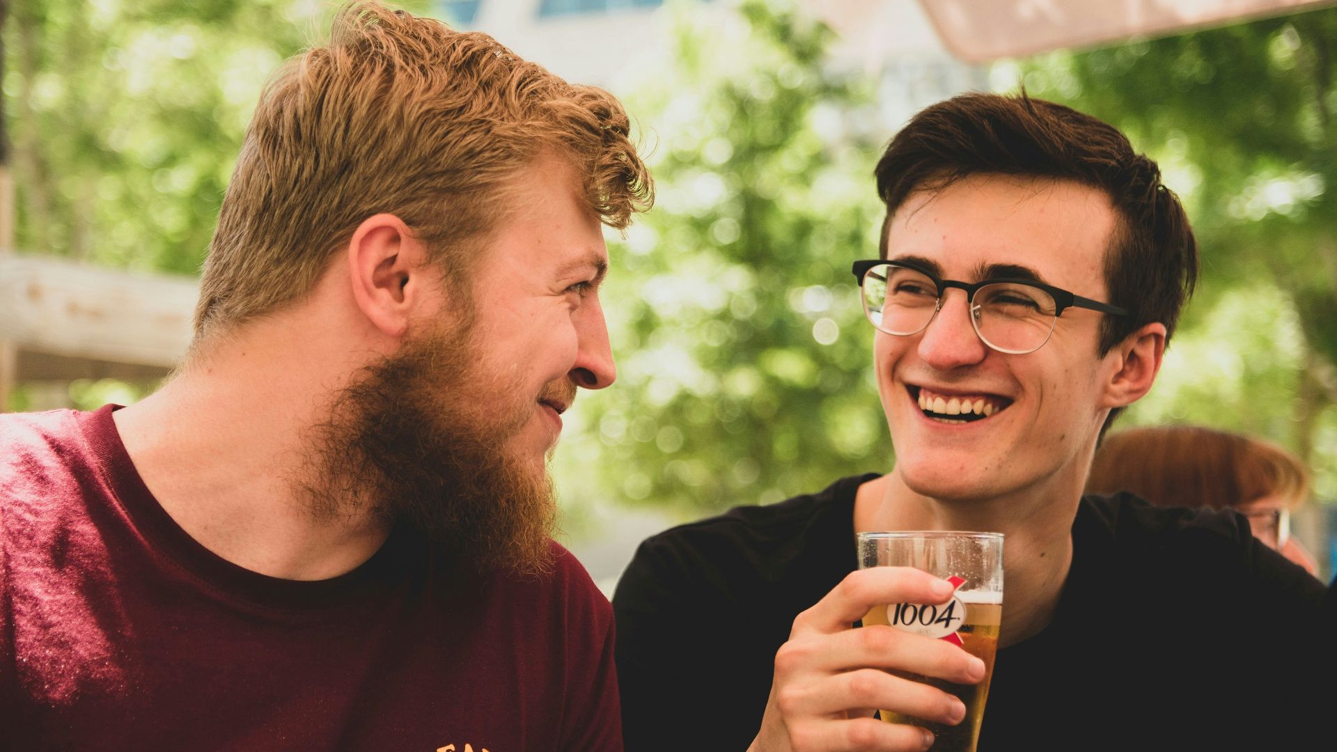 two men smiling near trees