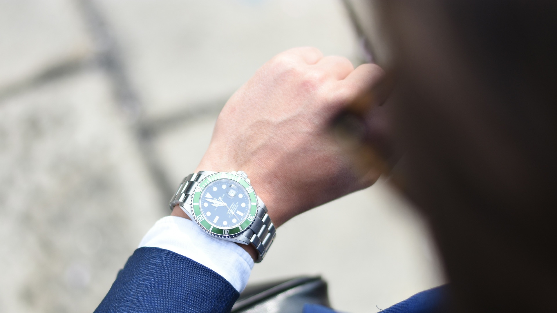 person looking at silver-colored analog watch
