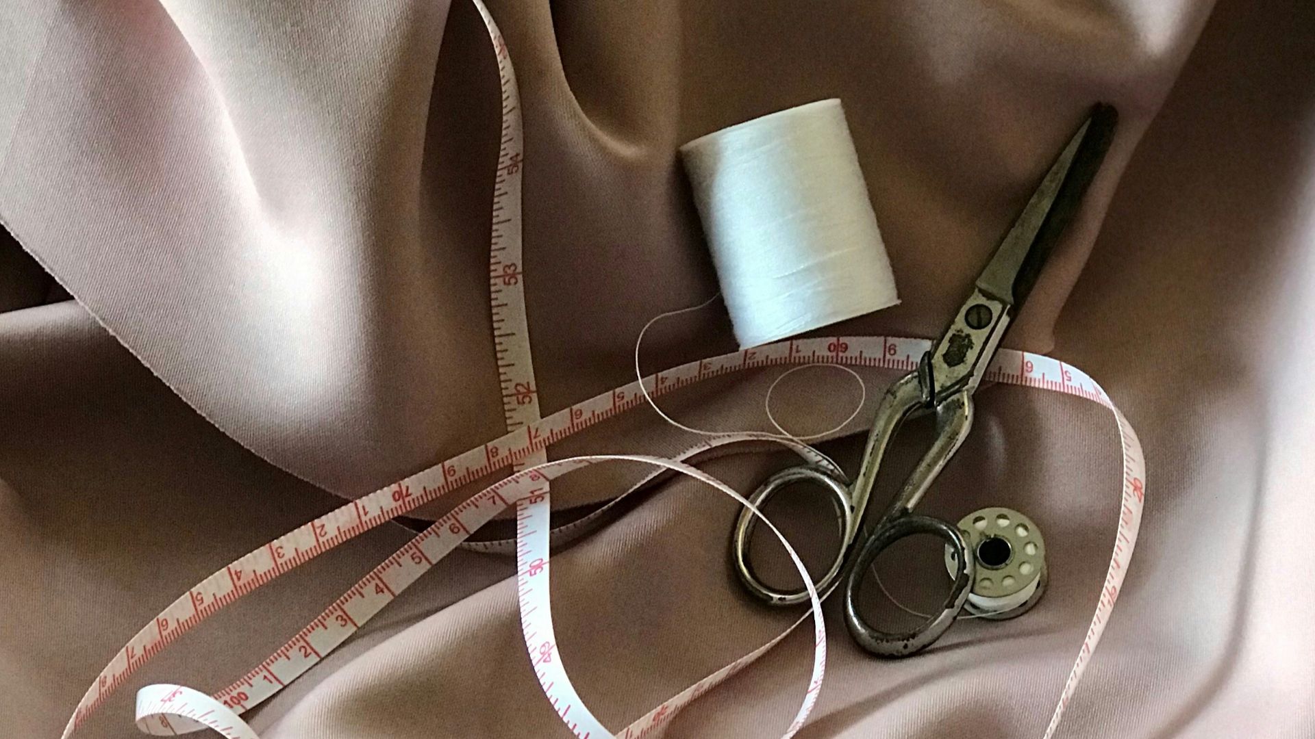 white tape measure and gray scissors