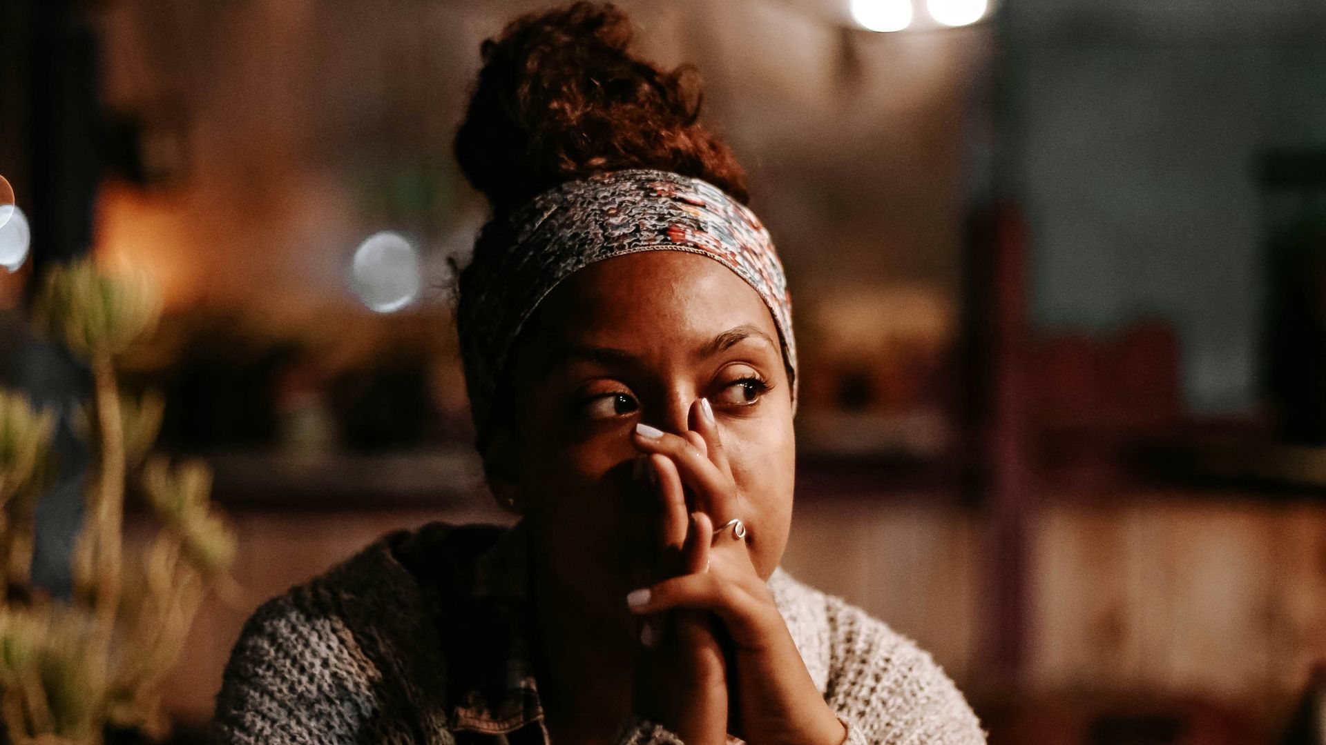 man in black and white sweater sitting on chair