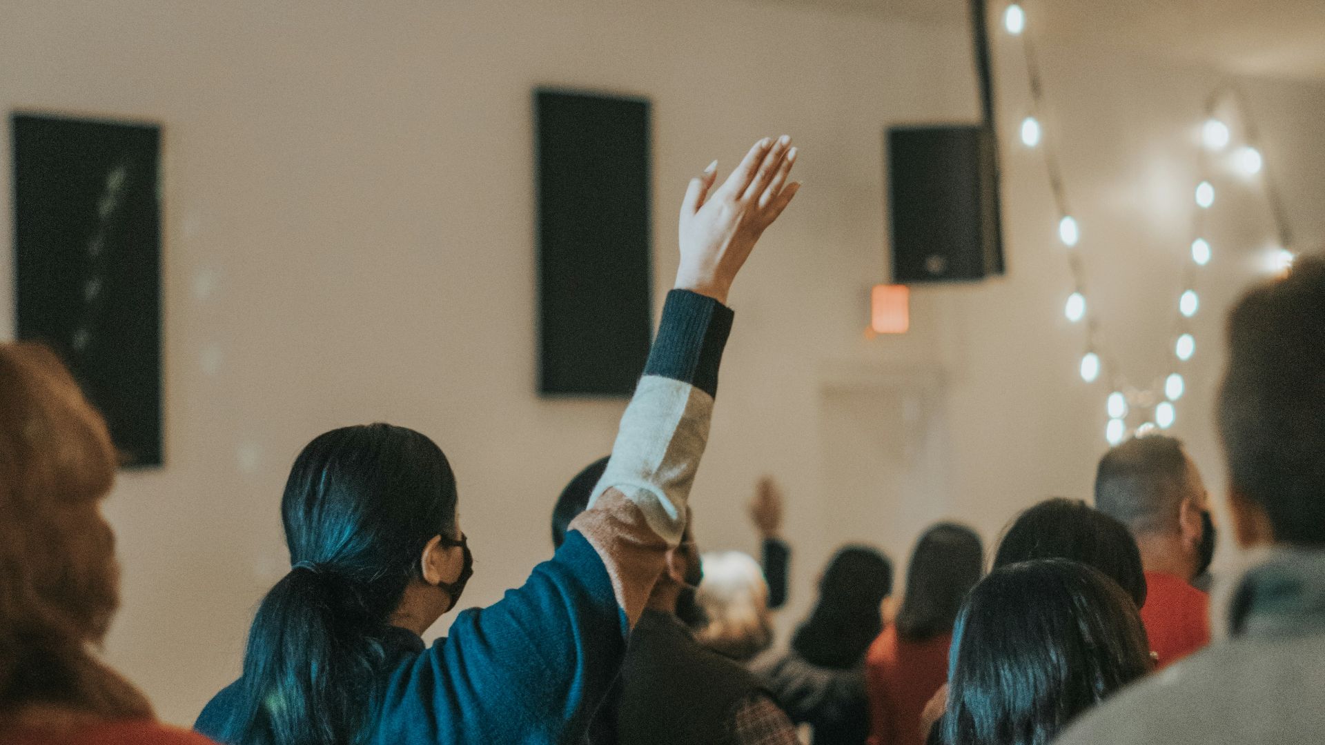 woman in blue long sleeve shirt holding black smartphone