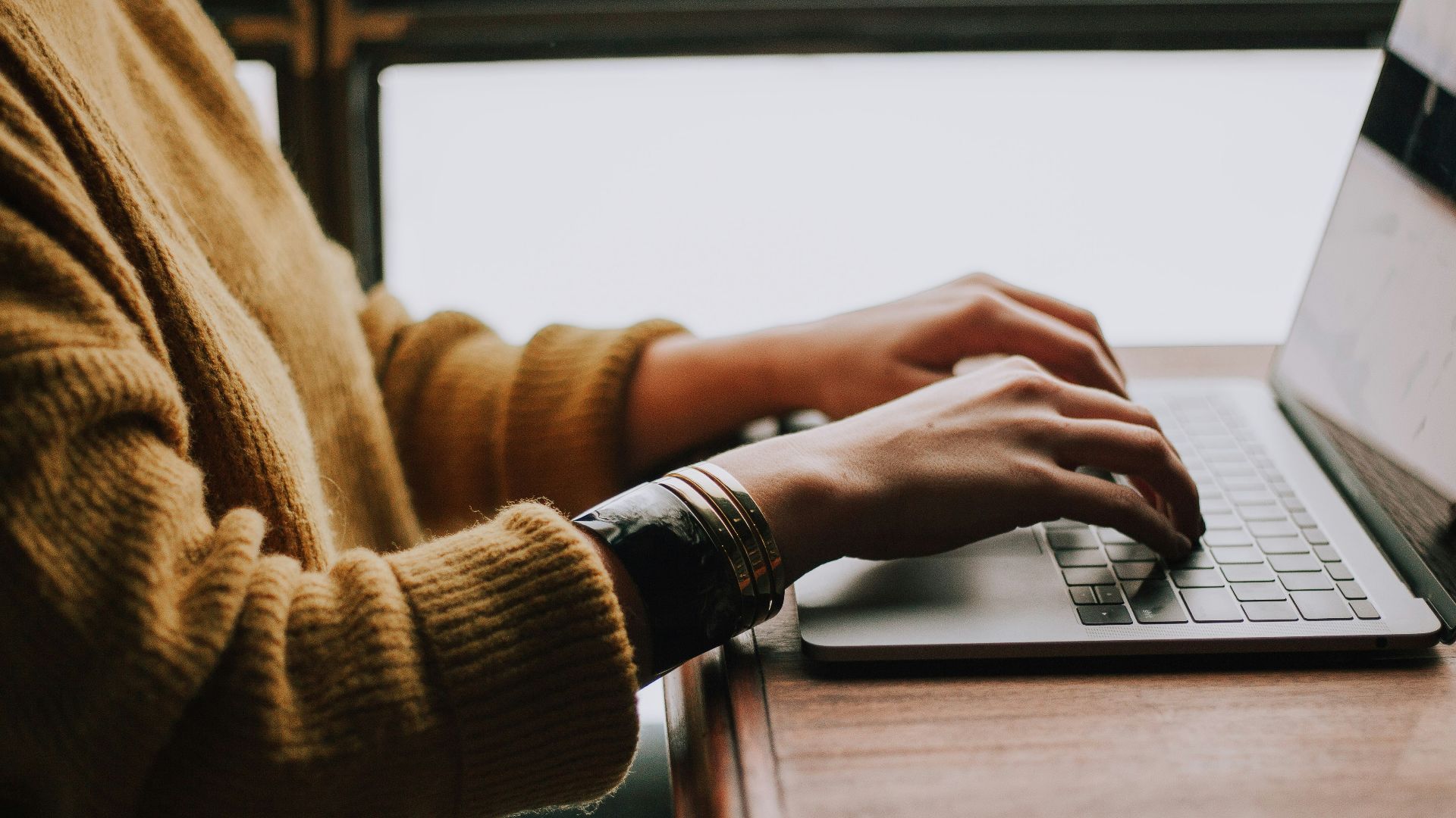 person sitting front of laptop