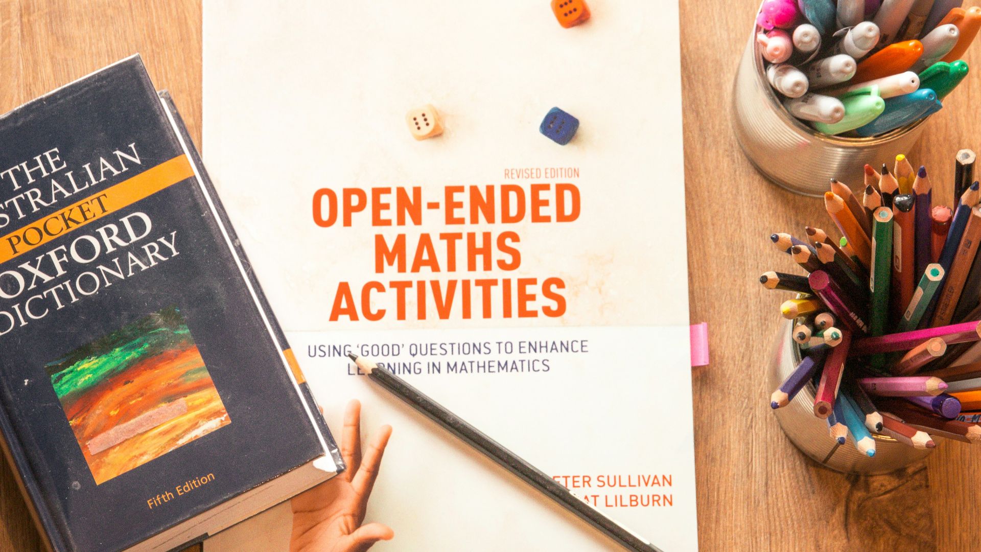 person holding a book and pen