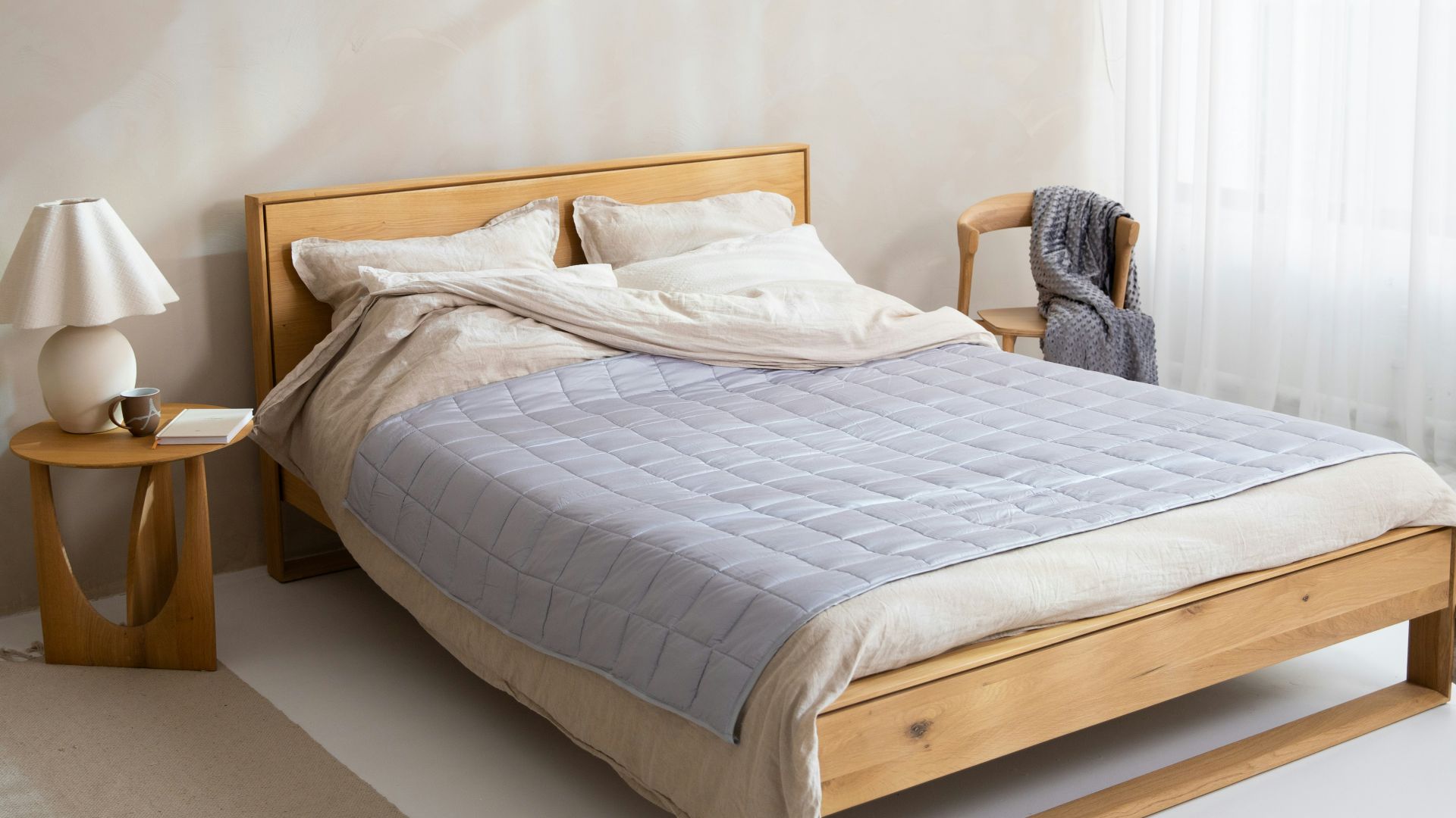 a bed sitting in a bedroom next to a window