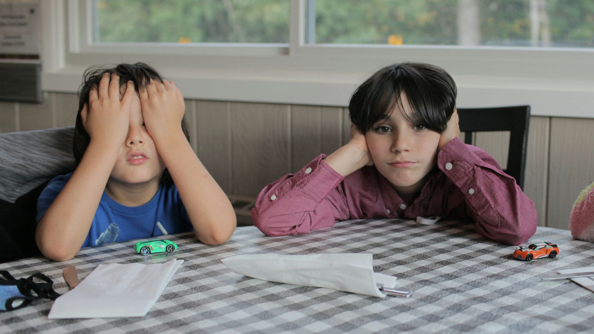 2 women sitting on chair in front of table