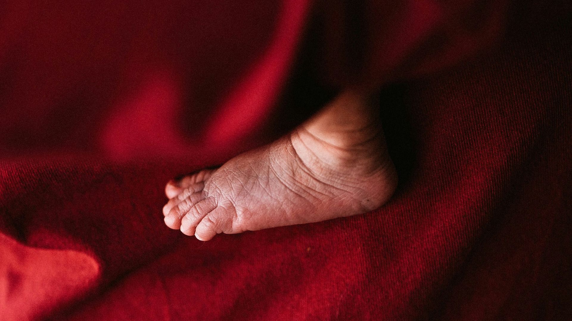 persons foot on red textile