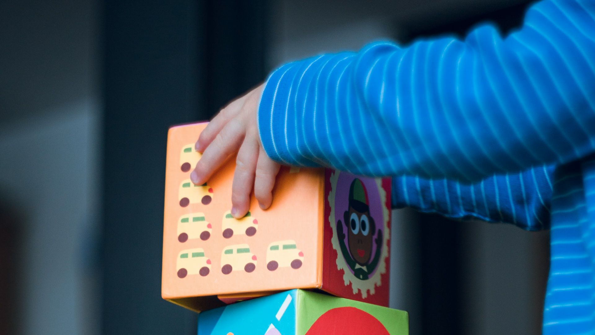 child building an four boxes