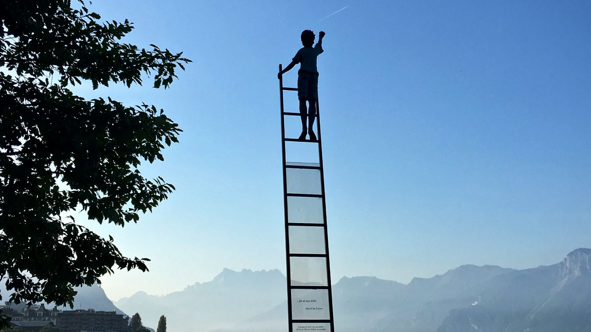 boy on ladder under blue sky