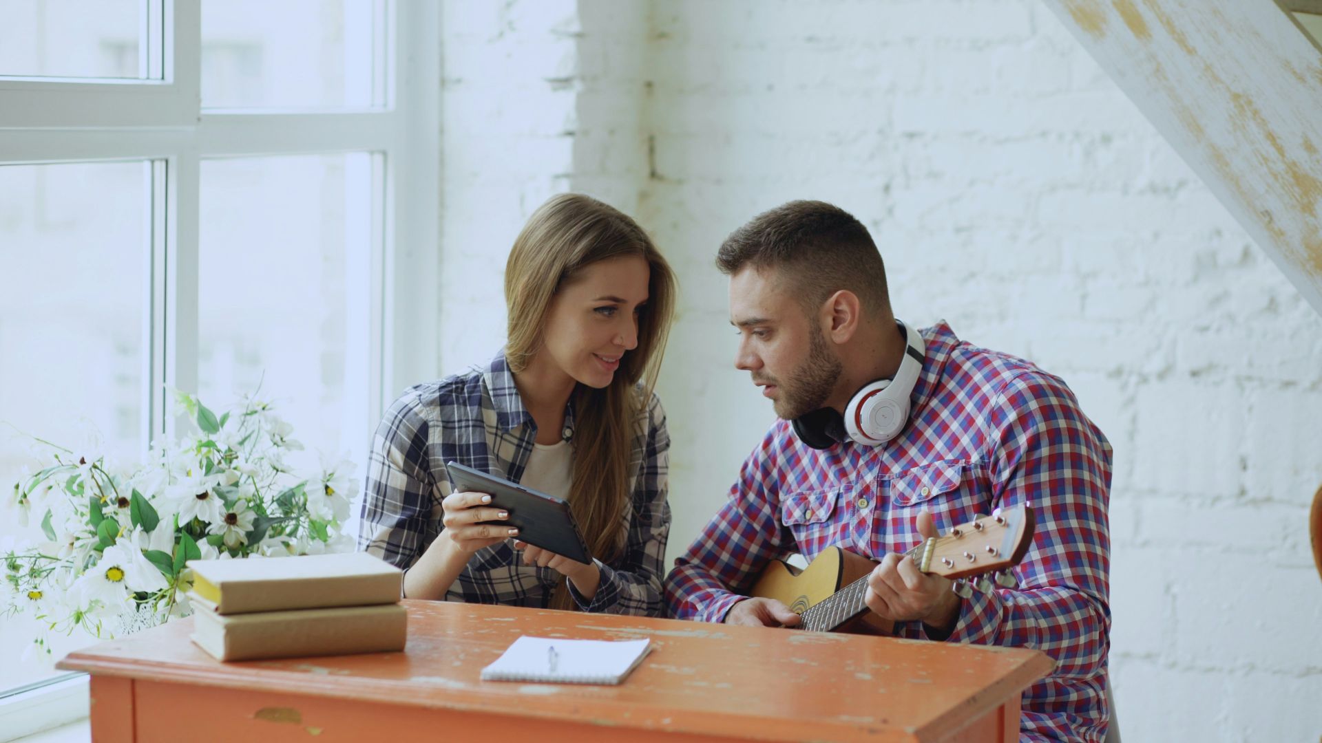 Couple looking at tablet by window