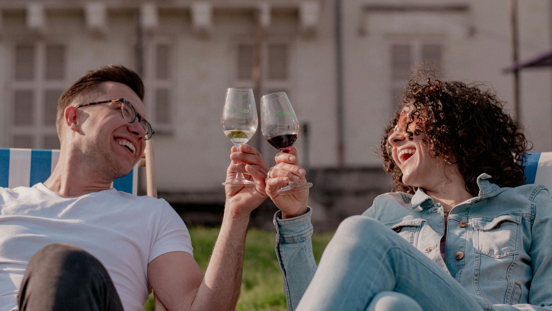 a man and a woman toasting with wine glasses