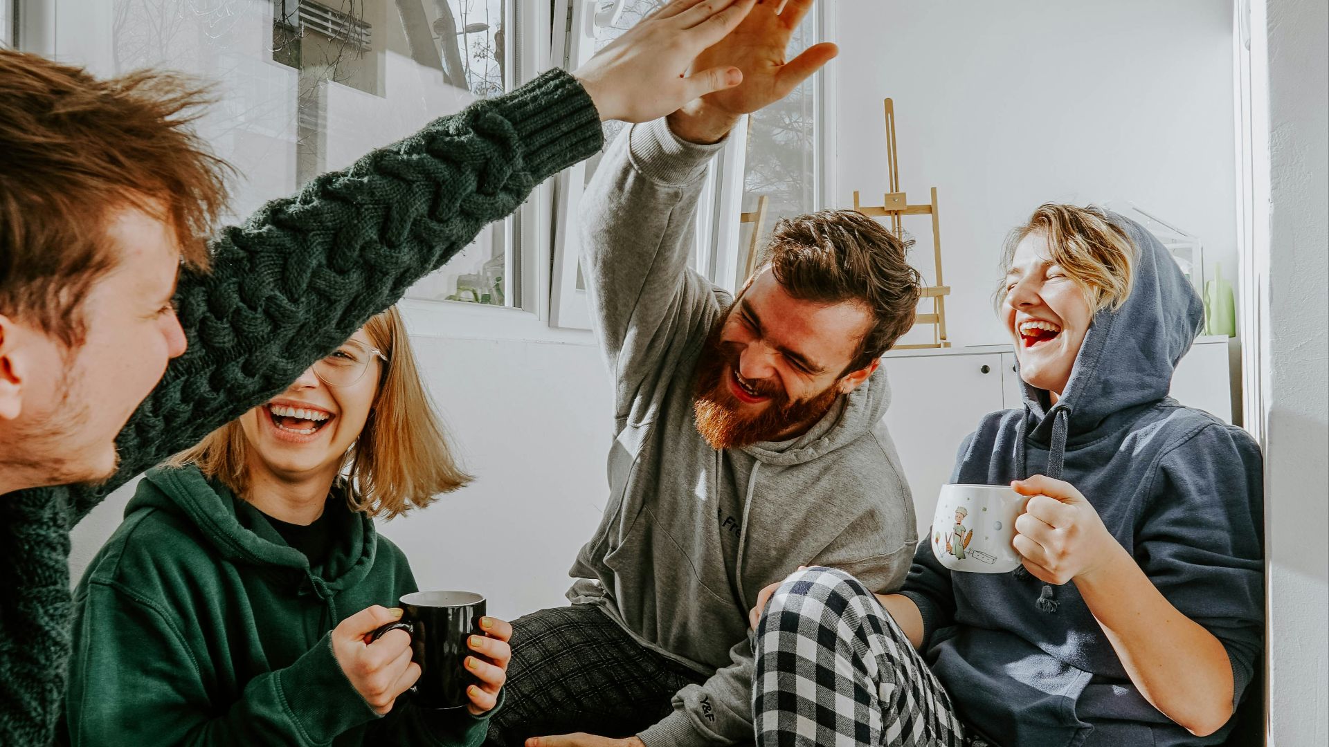 woman in black and white checkered long sleeve shirt sitting beside man in green crew neck