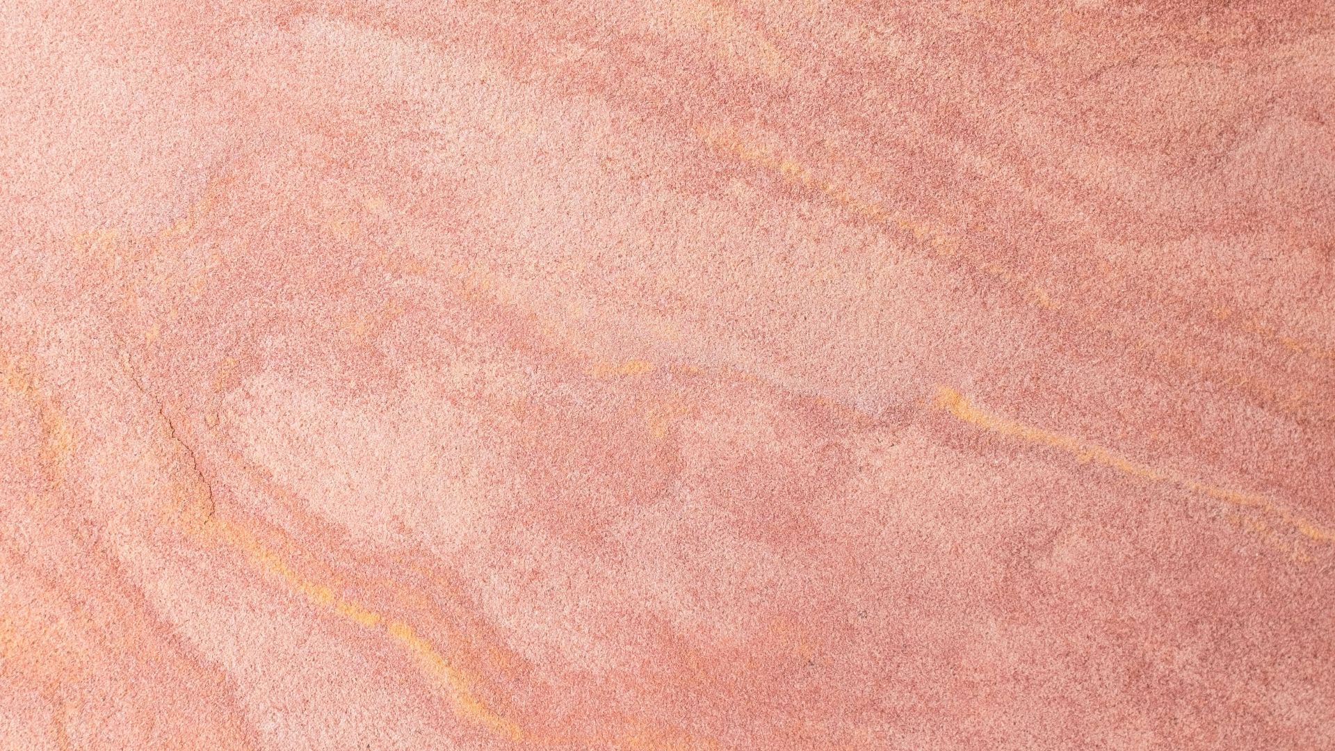 a skateboarder is riding on a pink surface