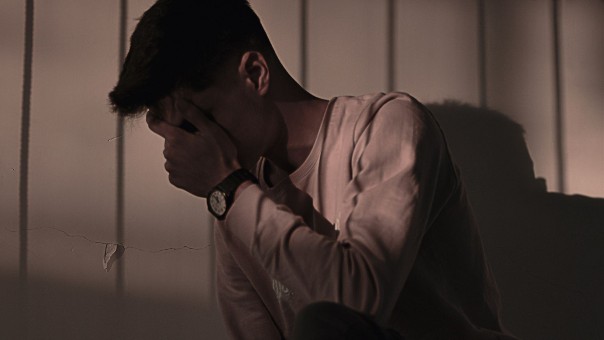 man in white dress shirt sitting on couch