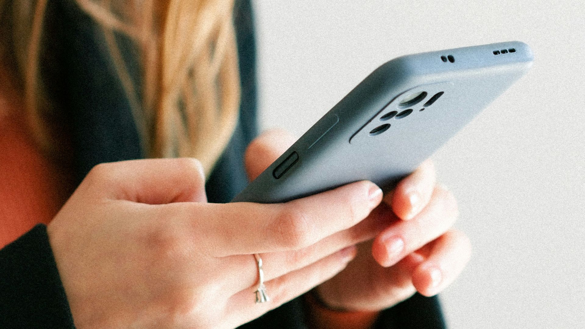 a woman holding a cell phone in her hands