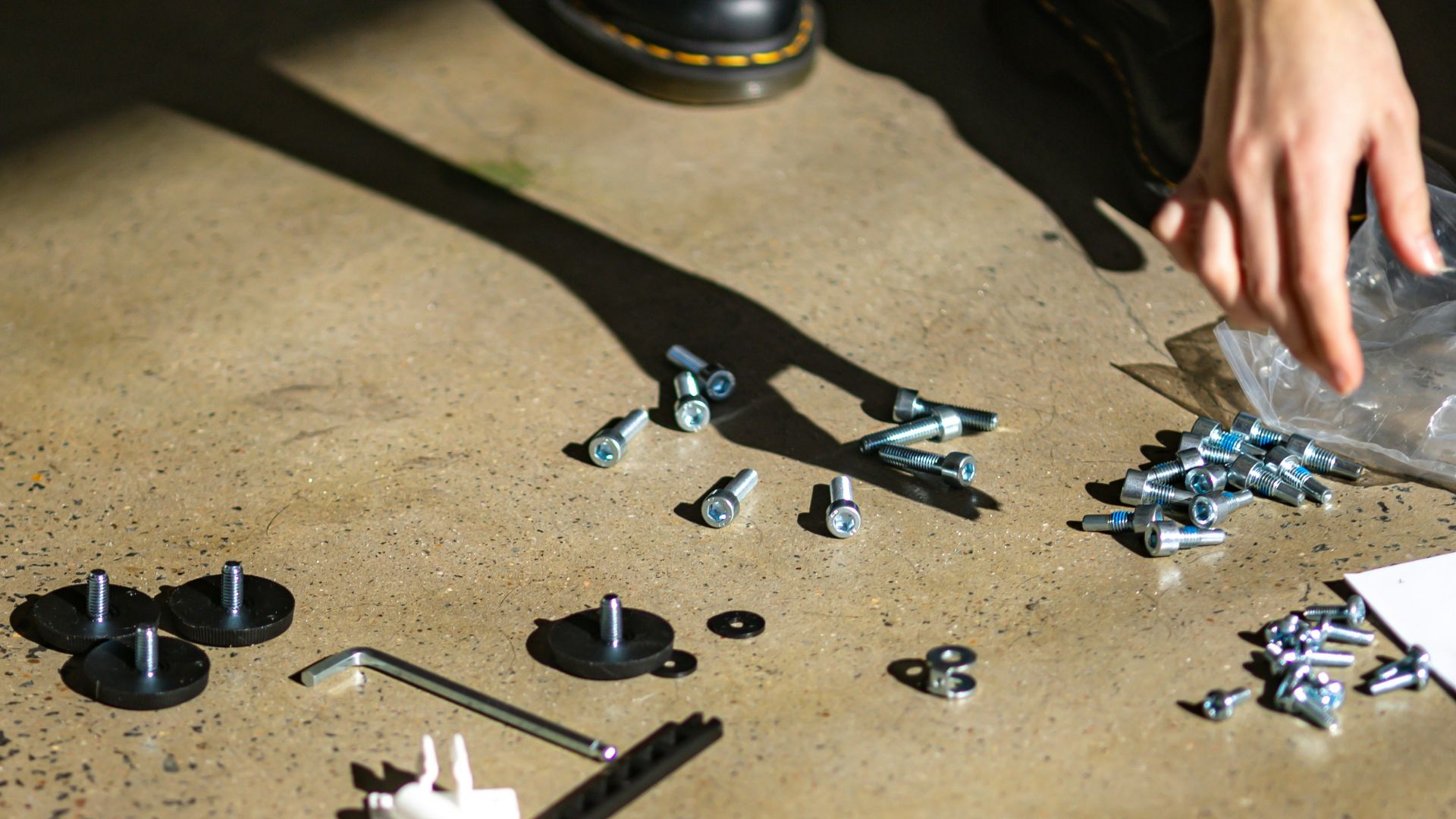 person holding silver and black gemstone accessory