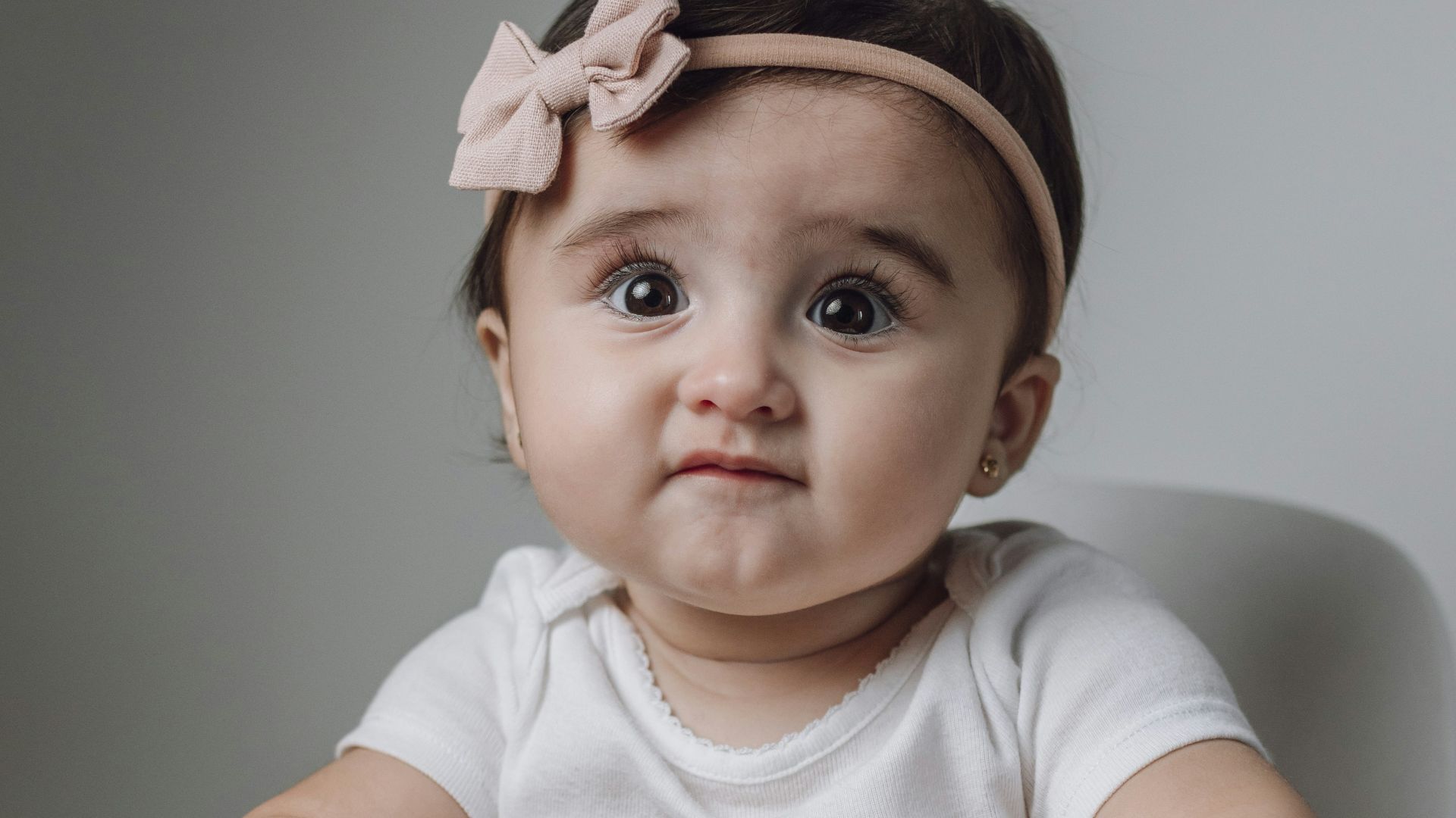 A baby girl sitting in a high chair