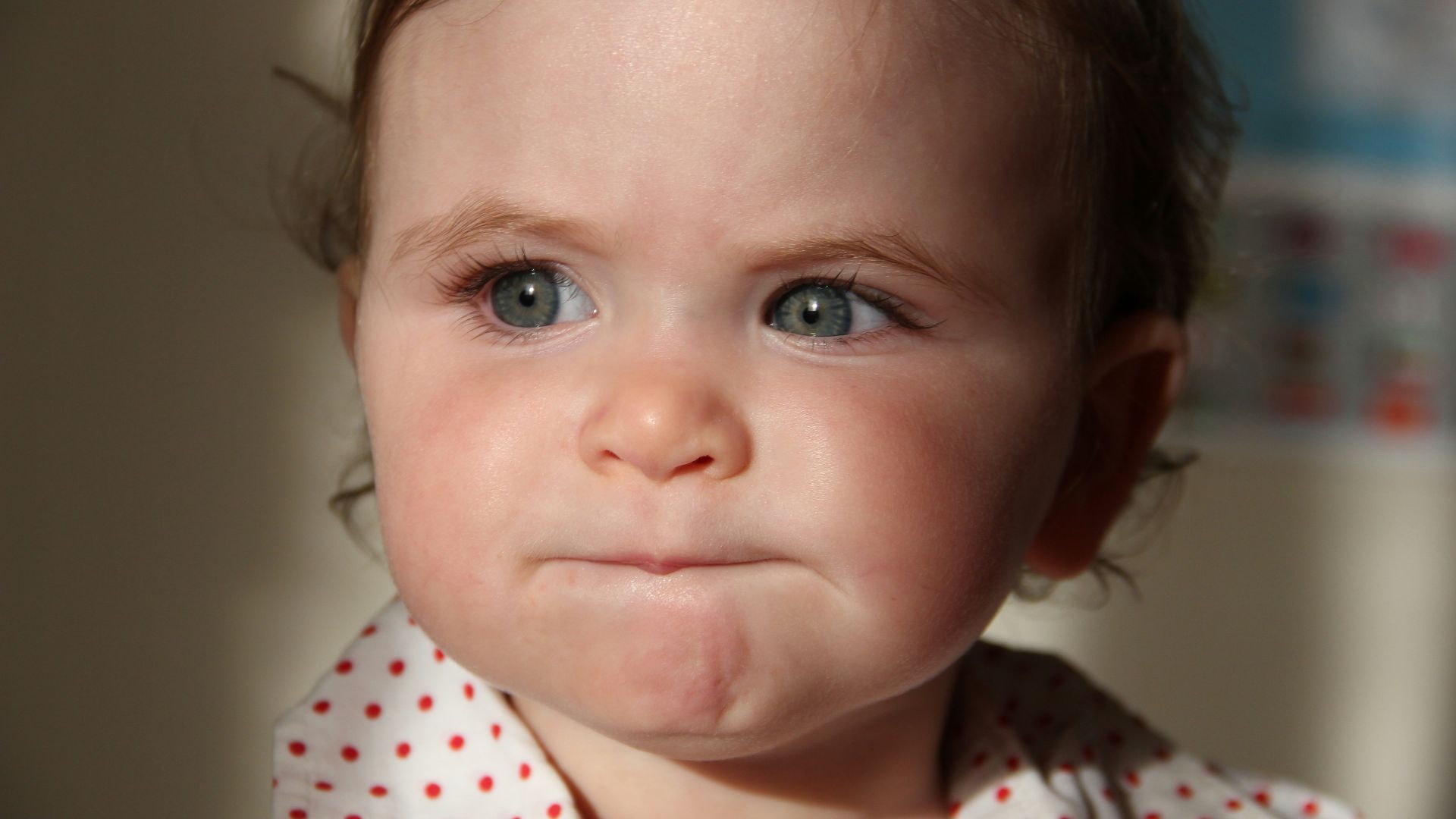 girl in white and red polka dot shirt