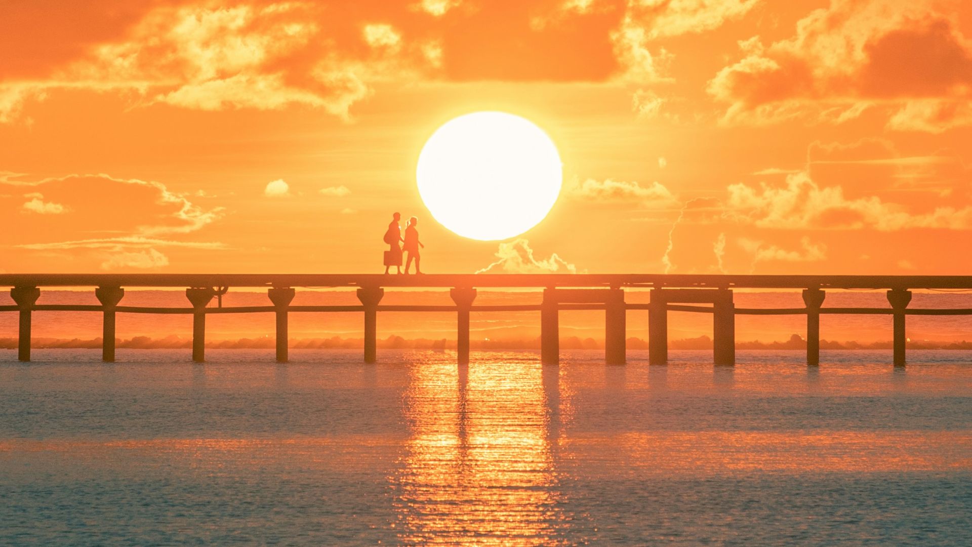 bridge over the sea during sunset