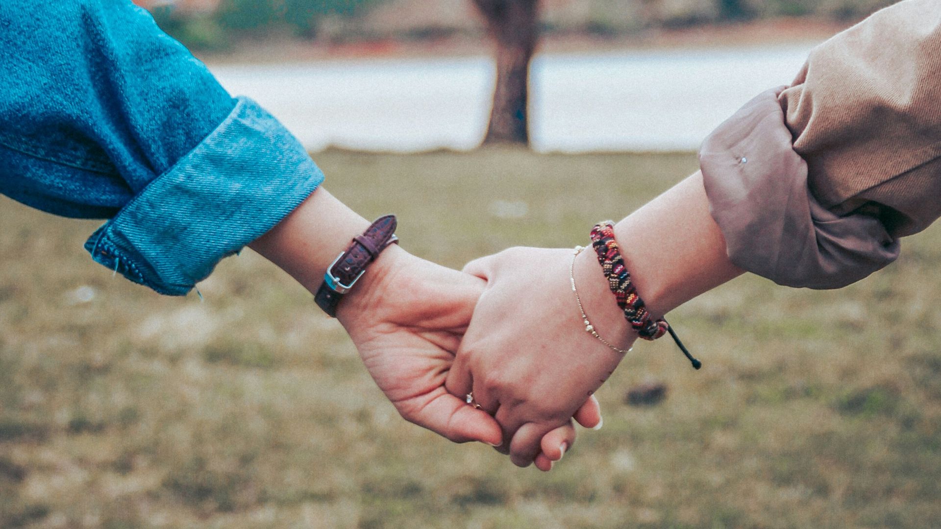 two persons holding hands