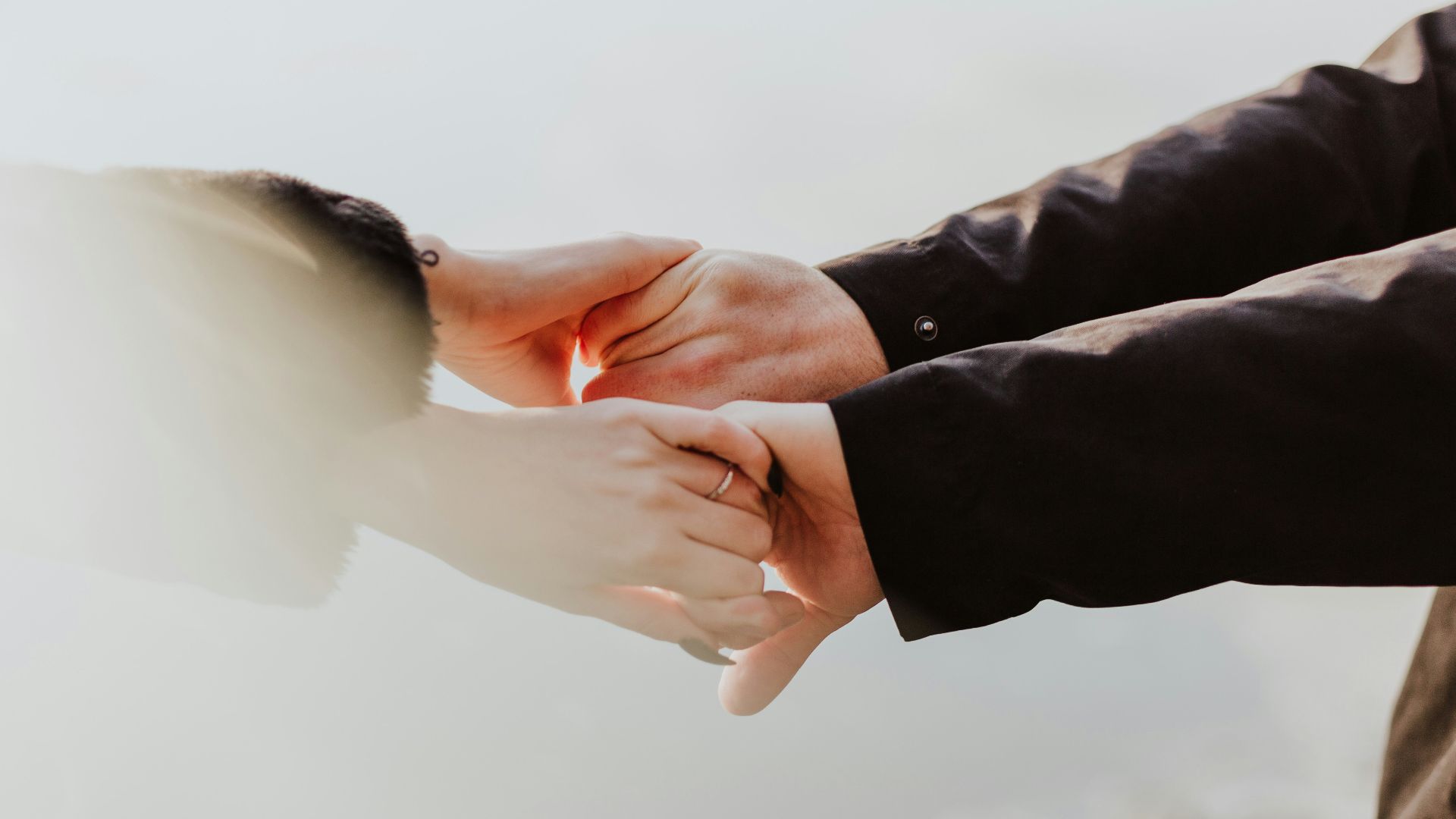 a couple holding hands while standing next to each other