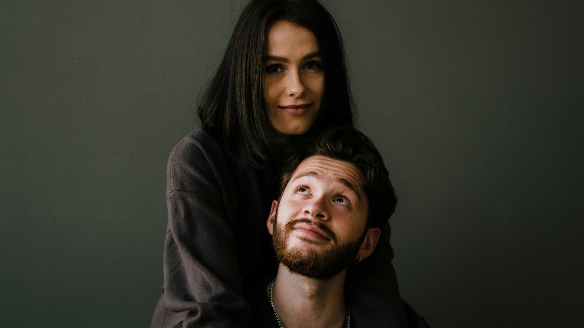 man in black crew neck shirt beside woman in black long sleeve shirt