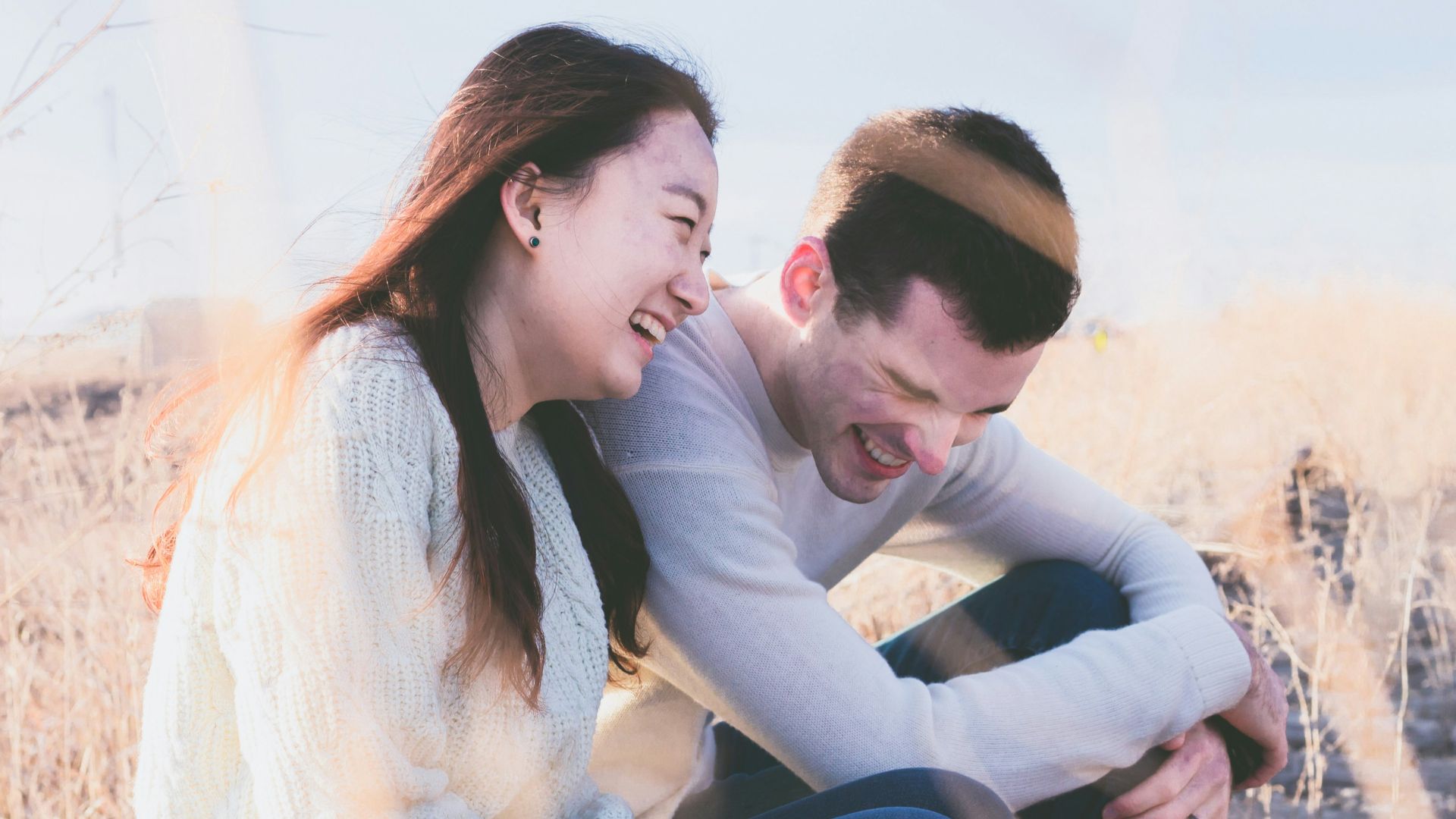 photo of man and woman laughing during daytime