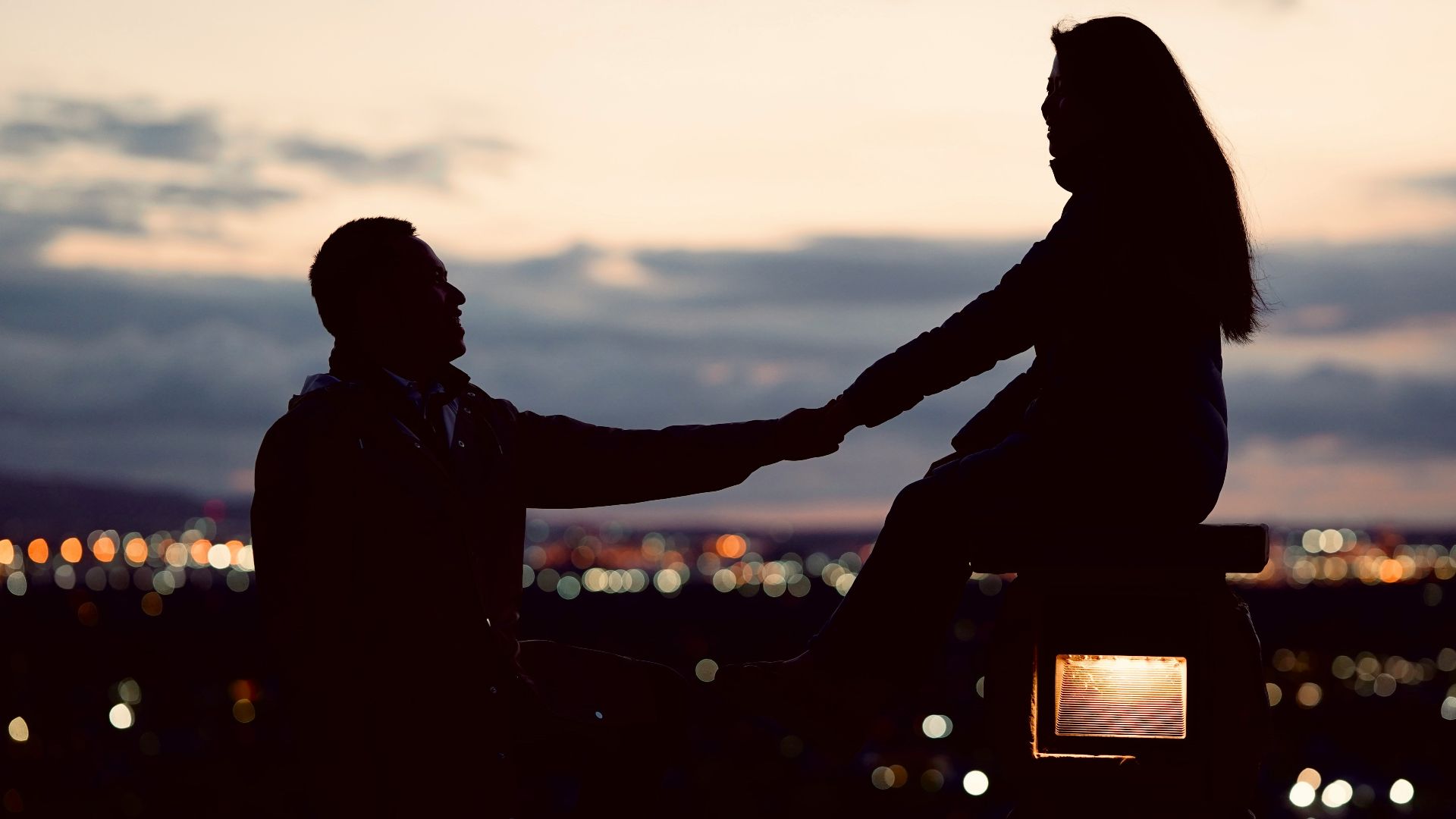 a couple of people sitting on top of a bench