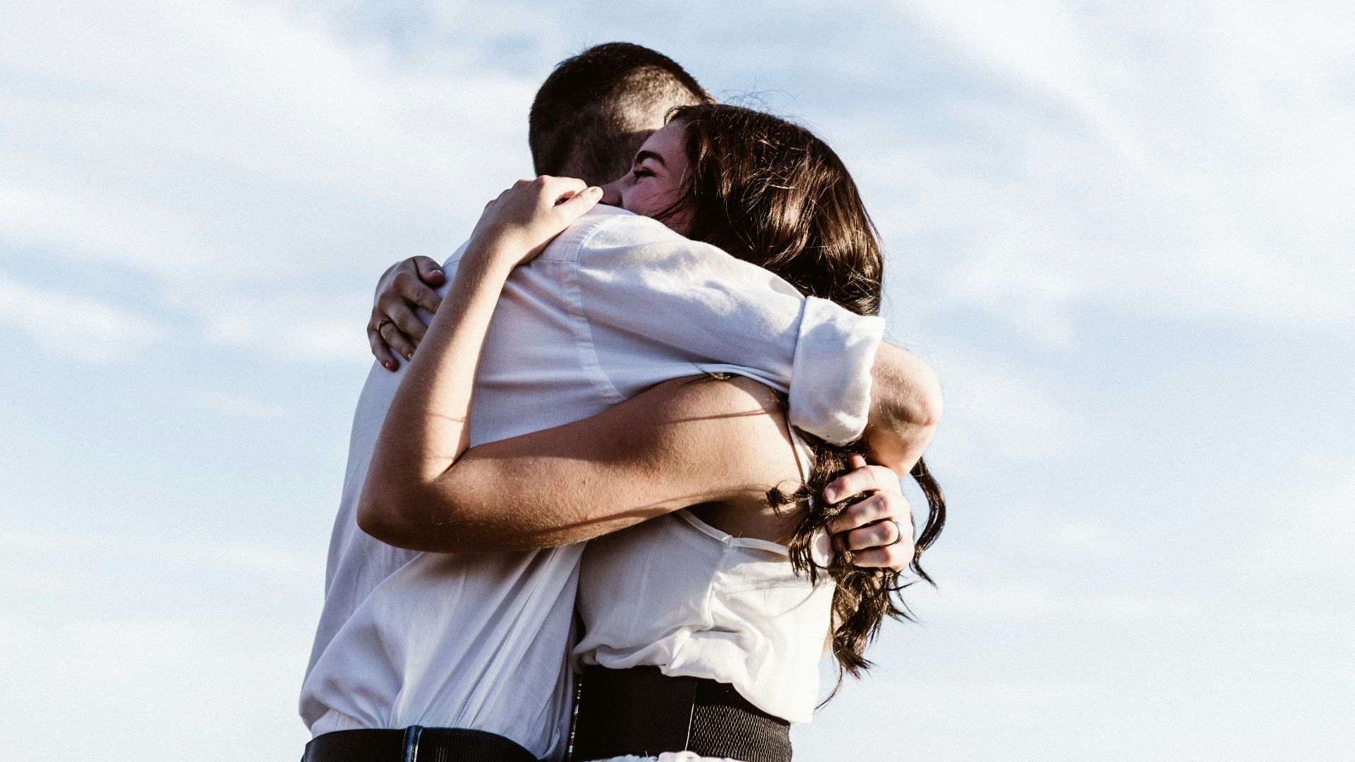 man and woman hugging each other photography
