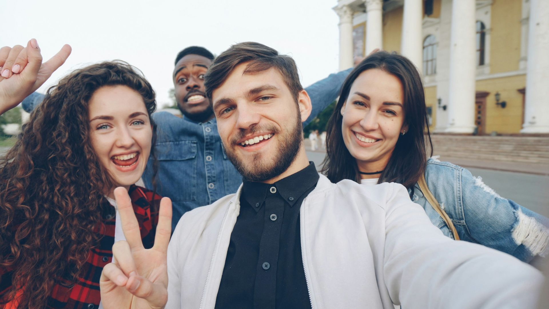 Happy friends are taking a selfie together.