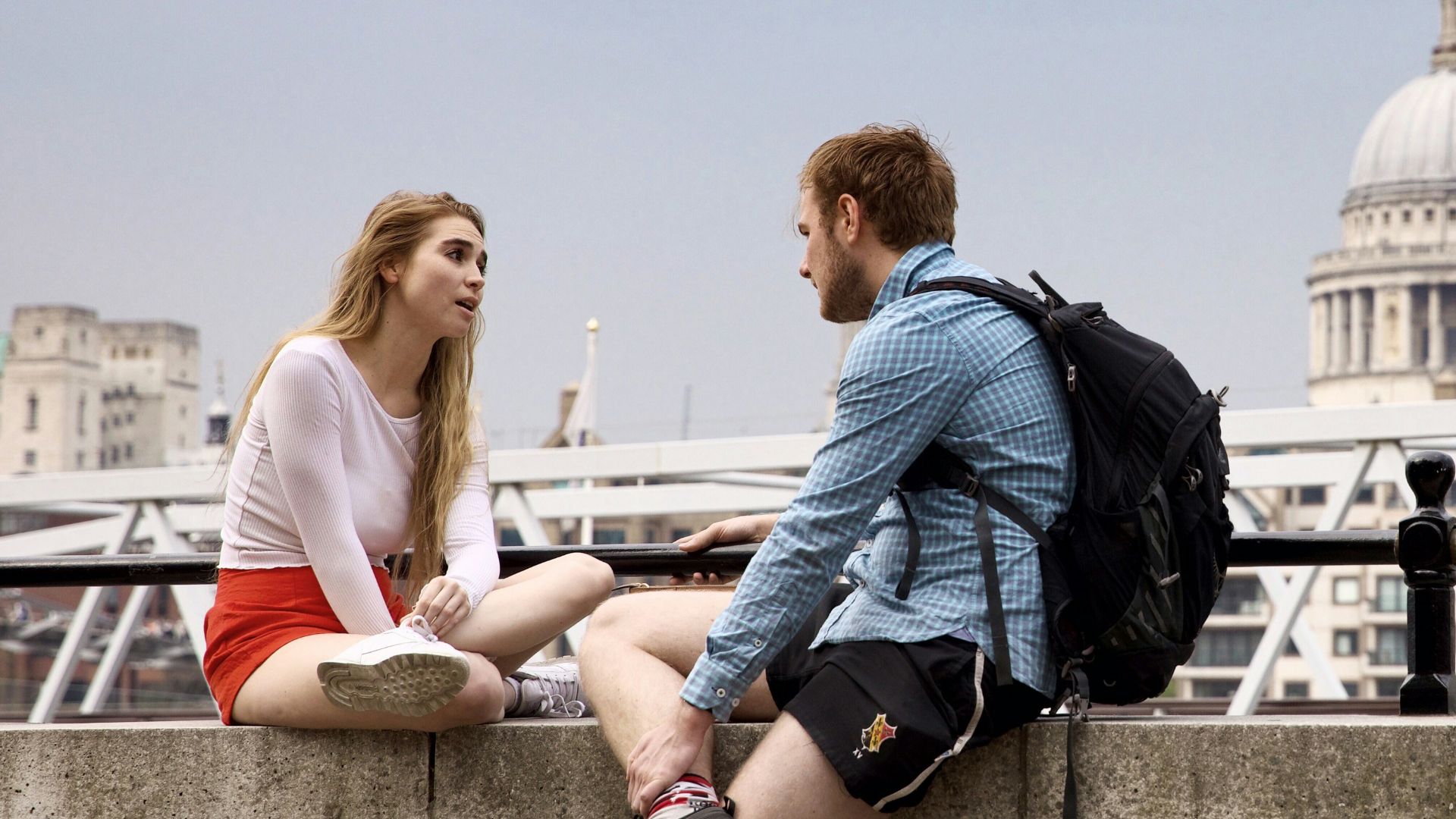 man and woman talking at the balcony
