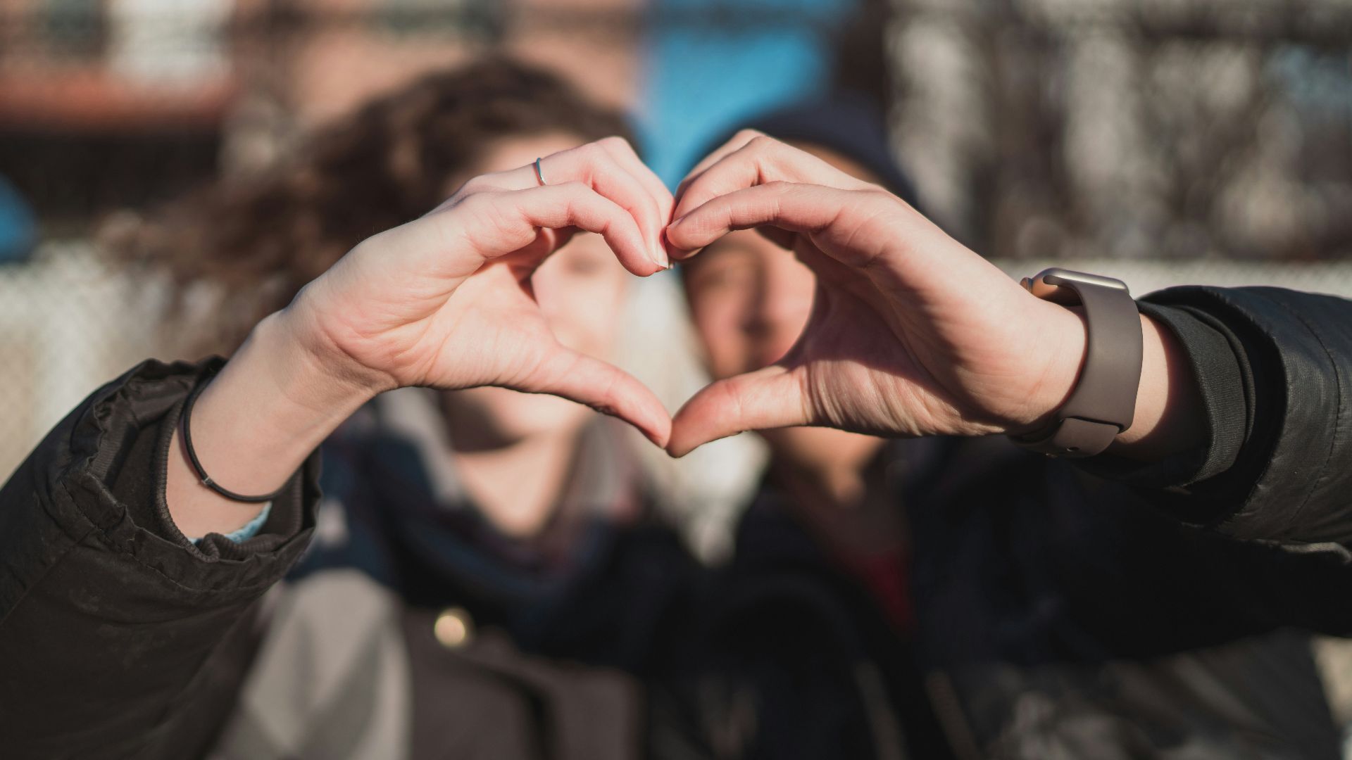 two person combine hand forming a heart hand gesture