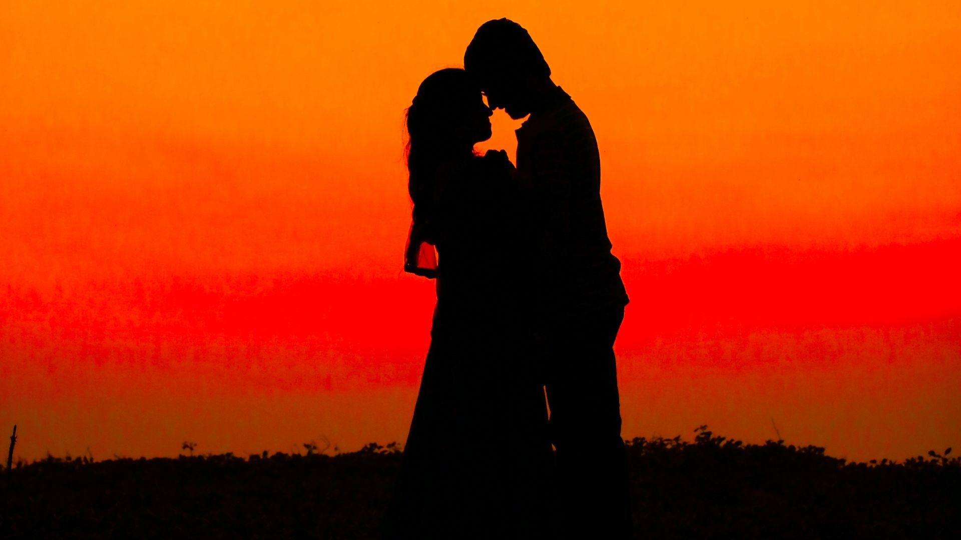 silhouette of man and woman during sunset