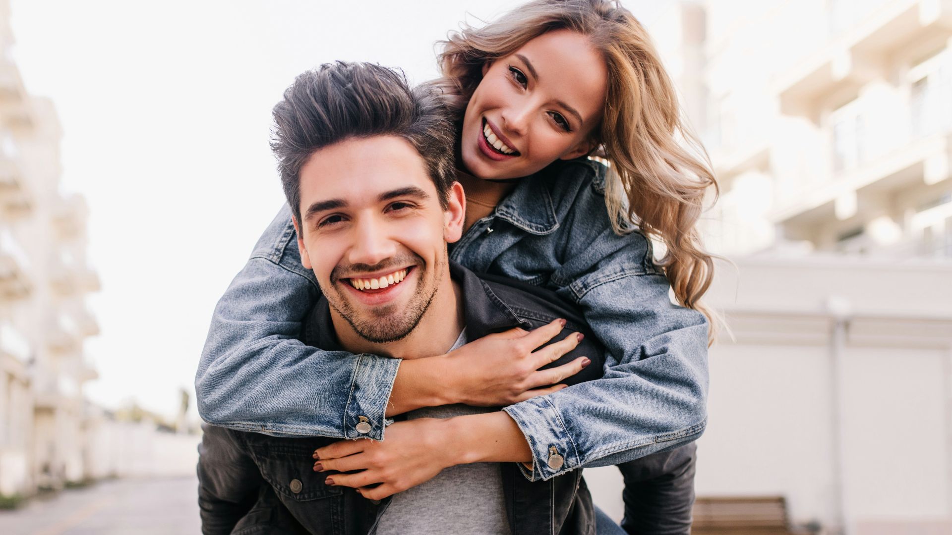 A man carrying a woman on his back