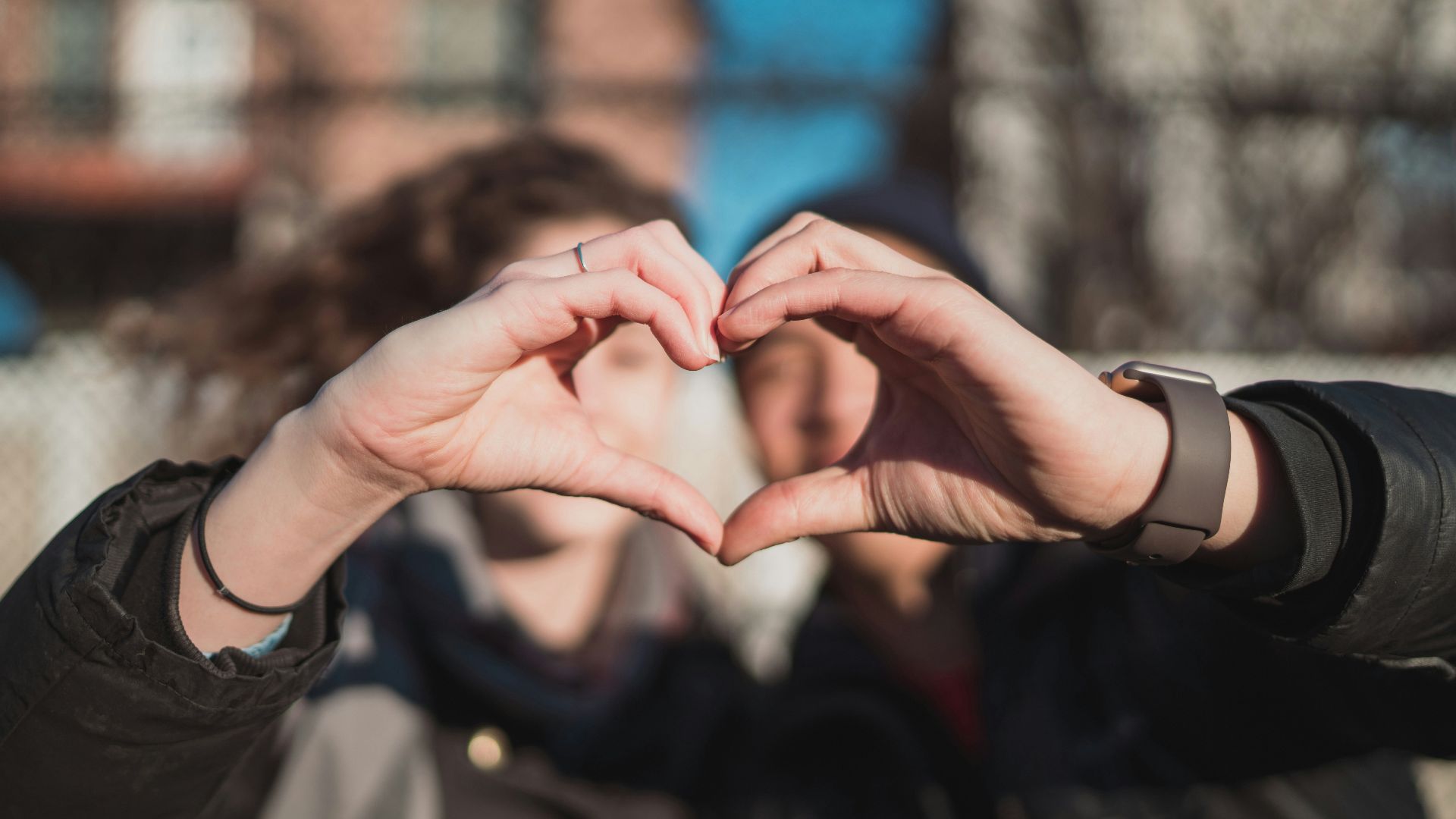 two person combine hand forming a heart hand gesture