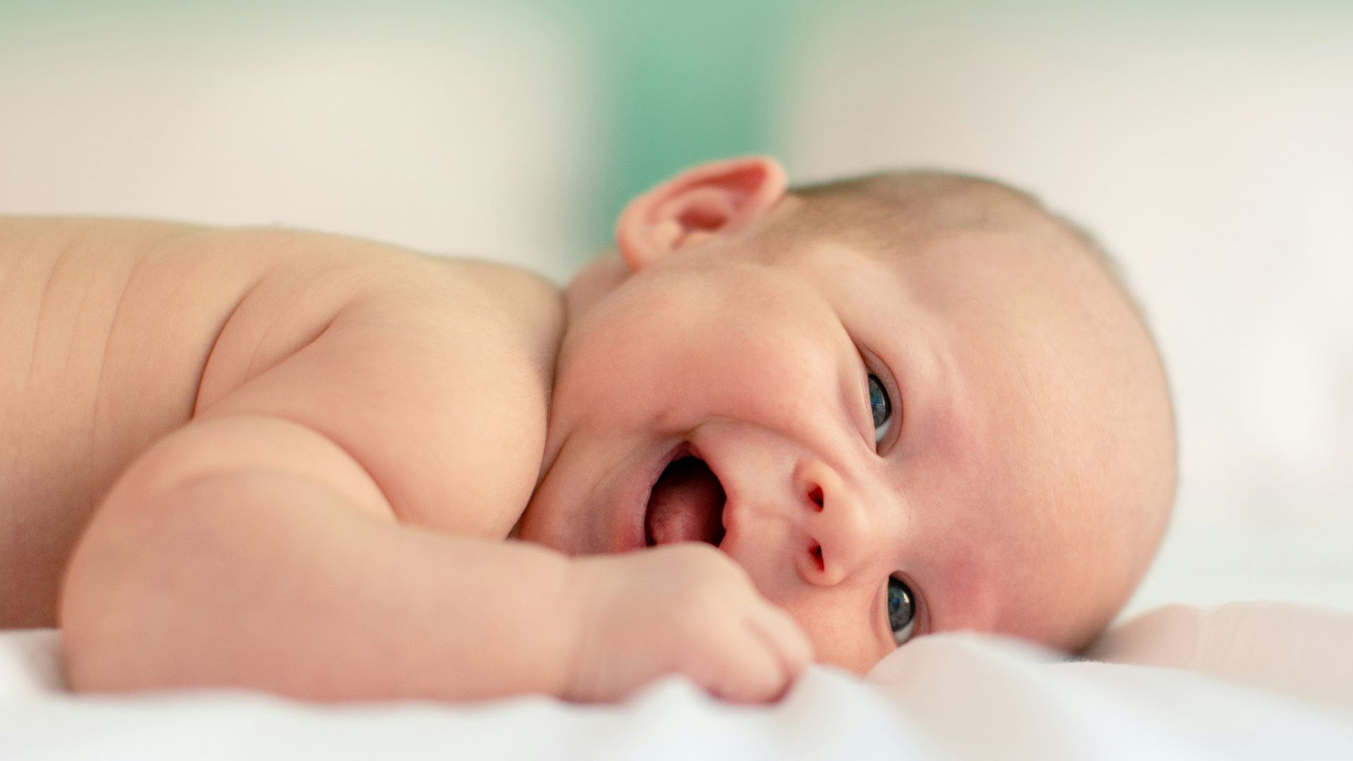 baby lying on fabric cloth