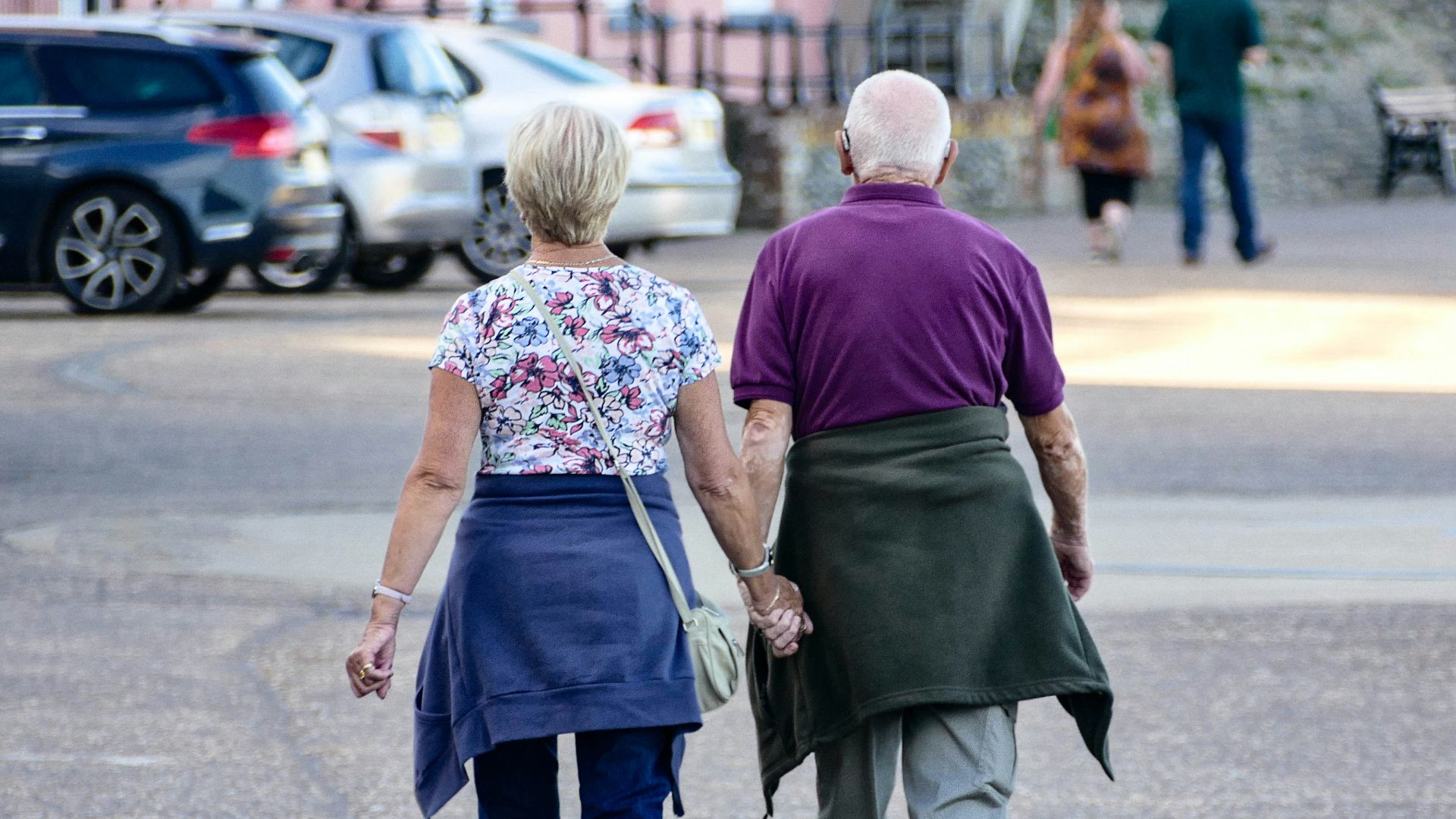 man and woman walking on the street during daytime