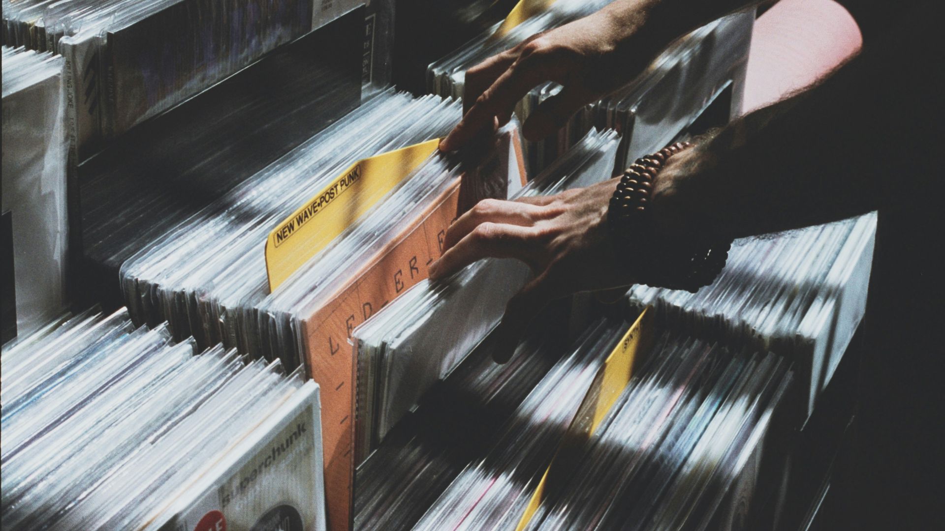 person taking photo of assorted vinyl album