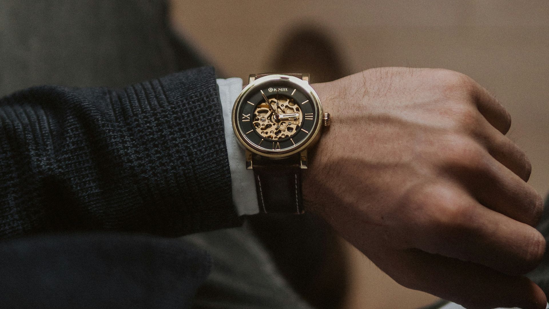 person wearing gold and silver round analog watch