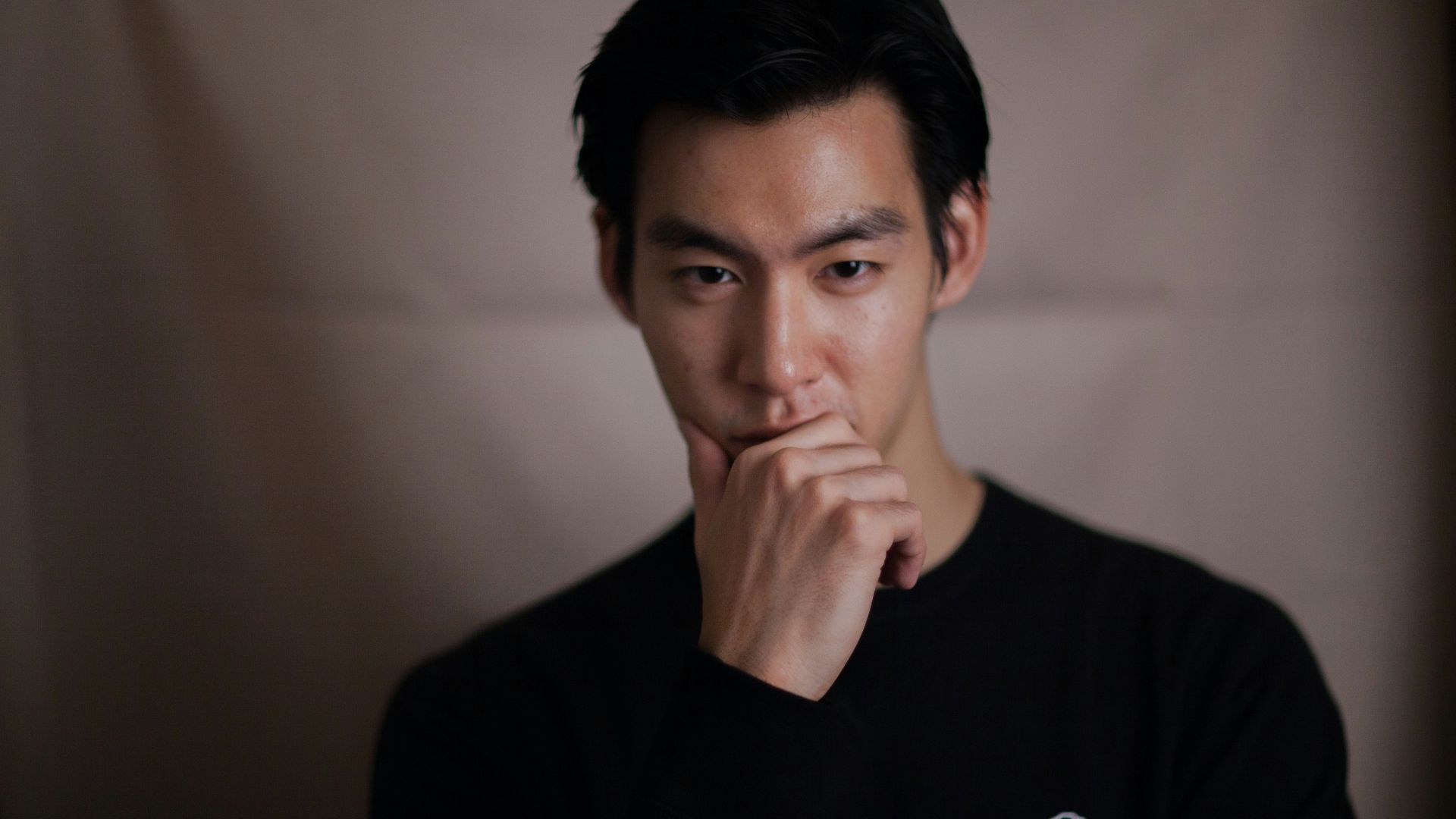 man touching his chin with right hand