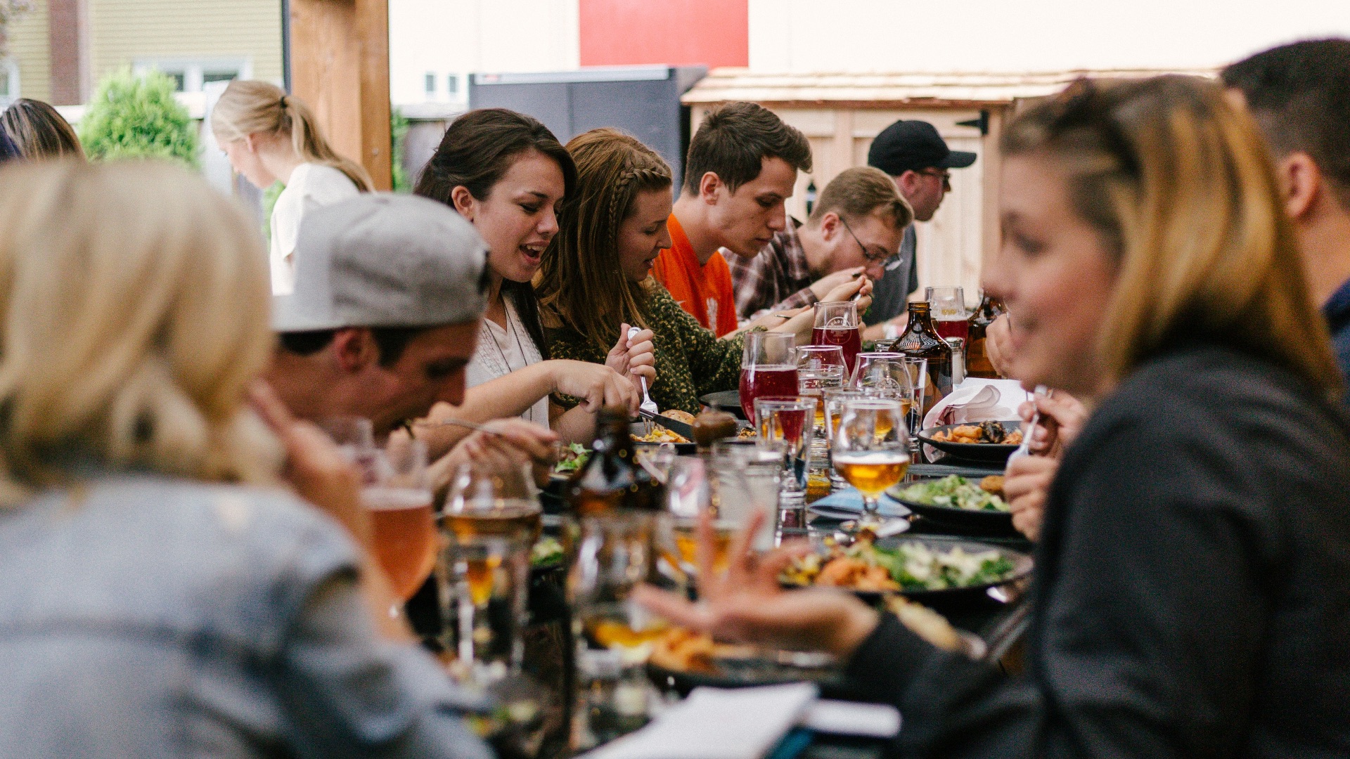 people sitting in front of table talking and eating