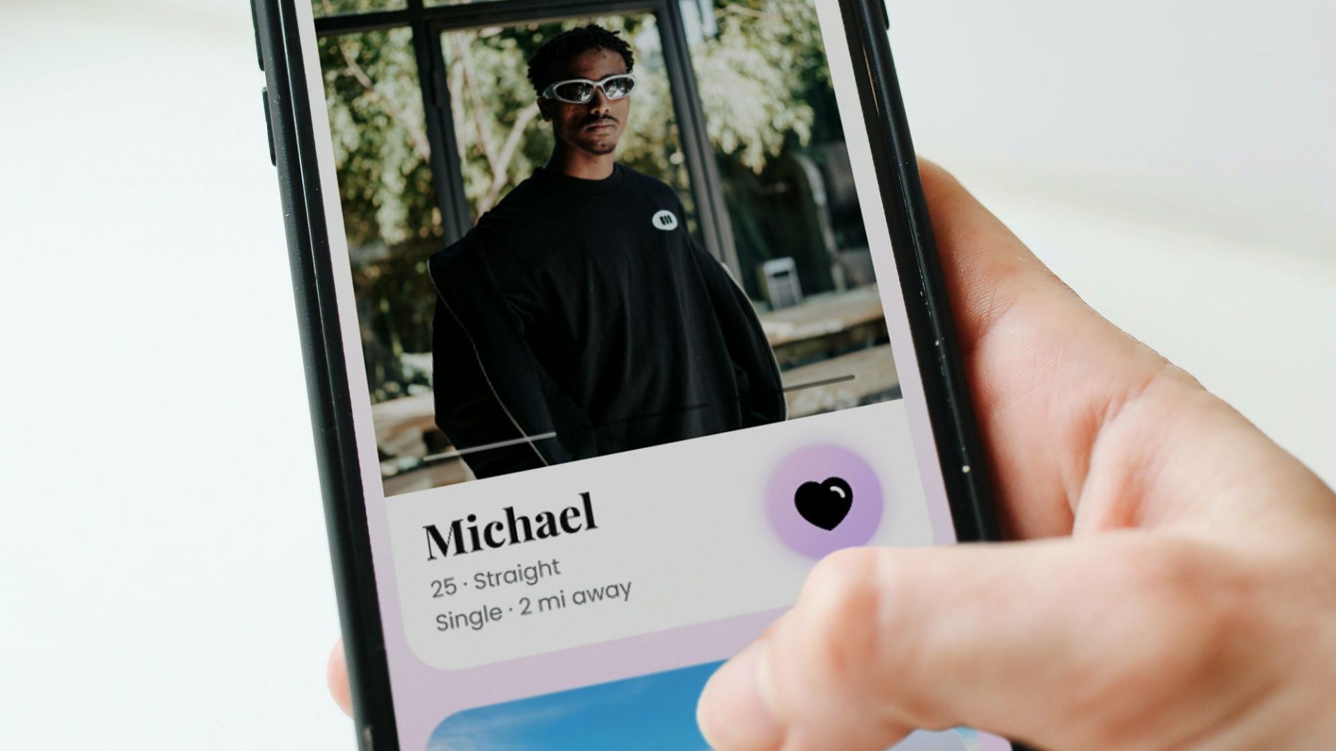 a person holding a cell phone with a picture of a man on it