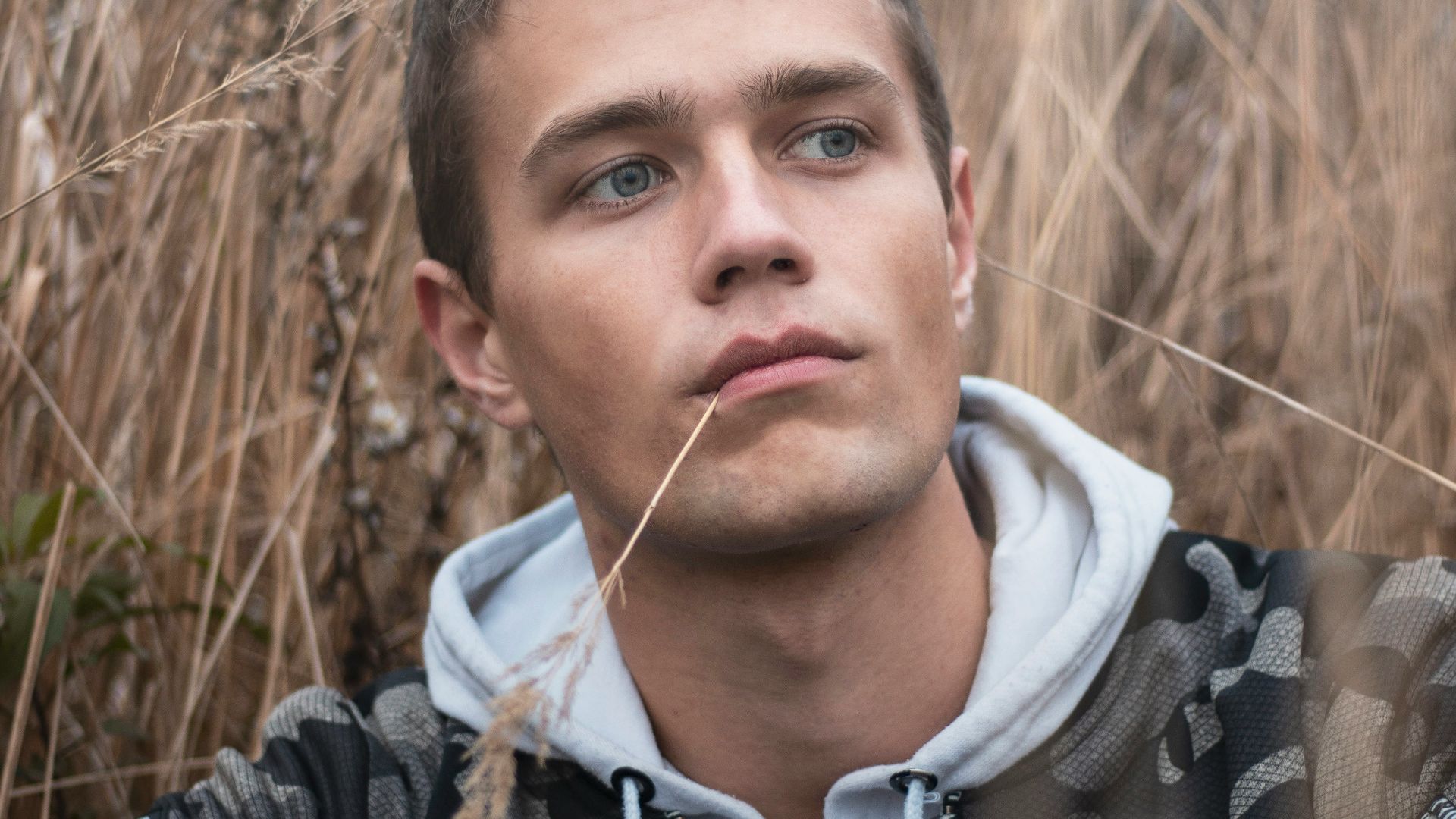 man surrounded by grass