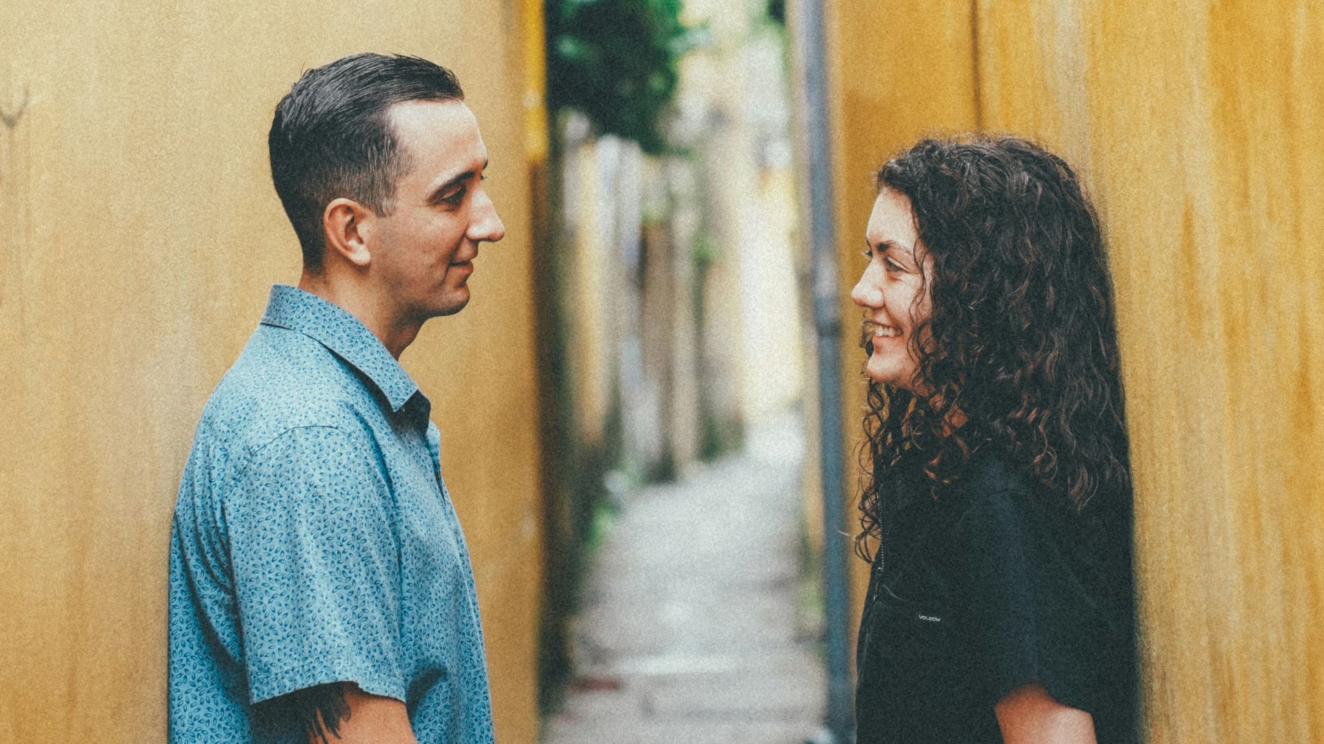 Couple standing in a narrow alleyway
