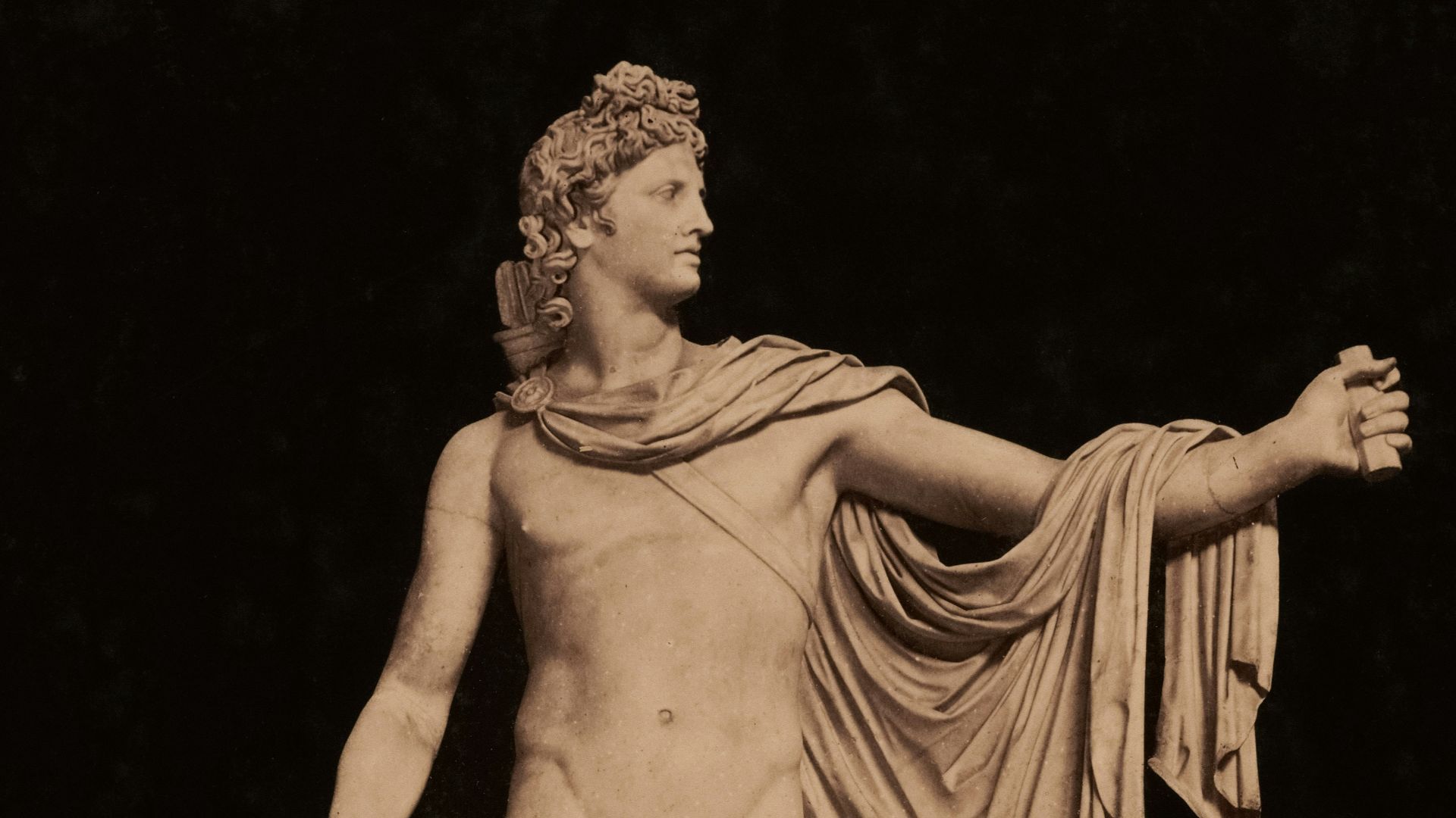 Apollo, the greek god, stands in white marble.