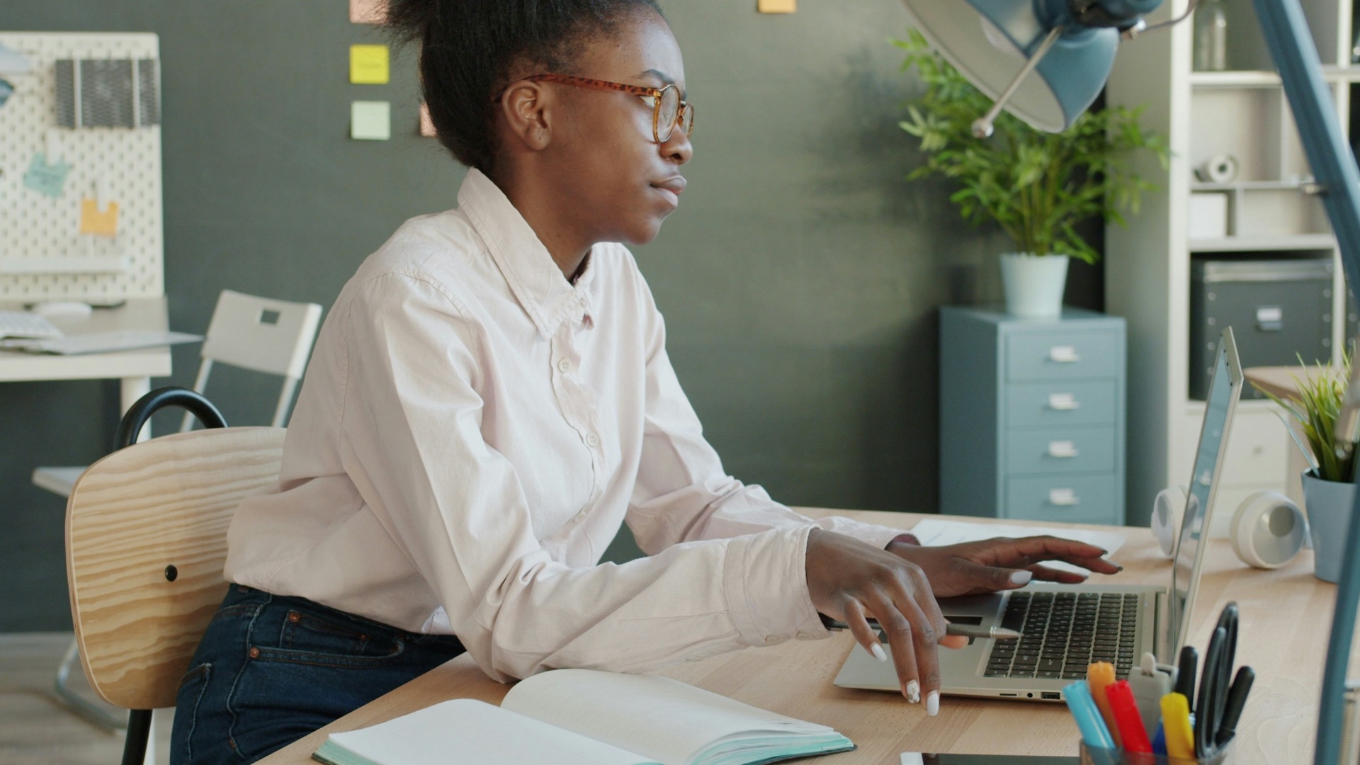 Young woman working at a desk in an office.