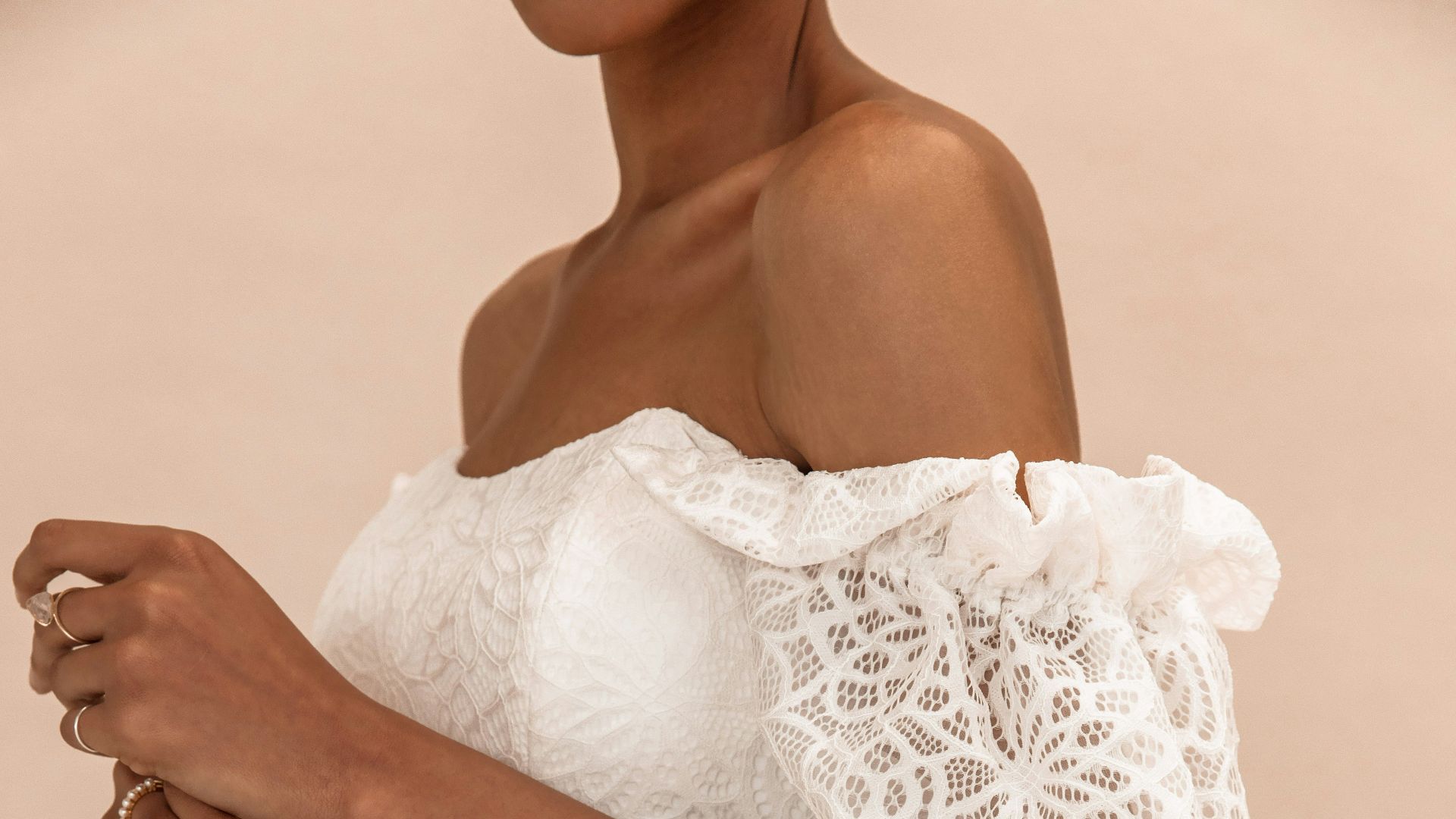 woman in white lace dress holding white bouquet