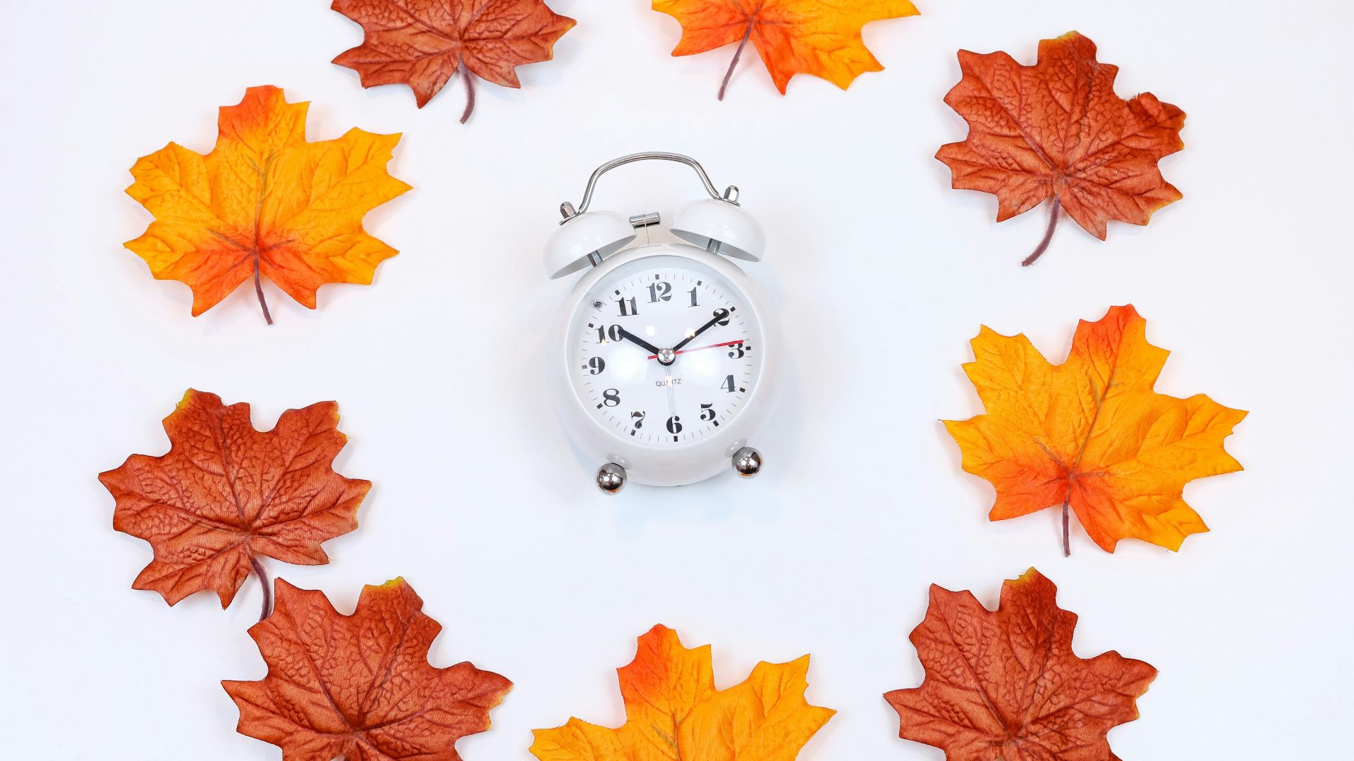 silver and white analog alarm clock