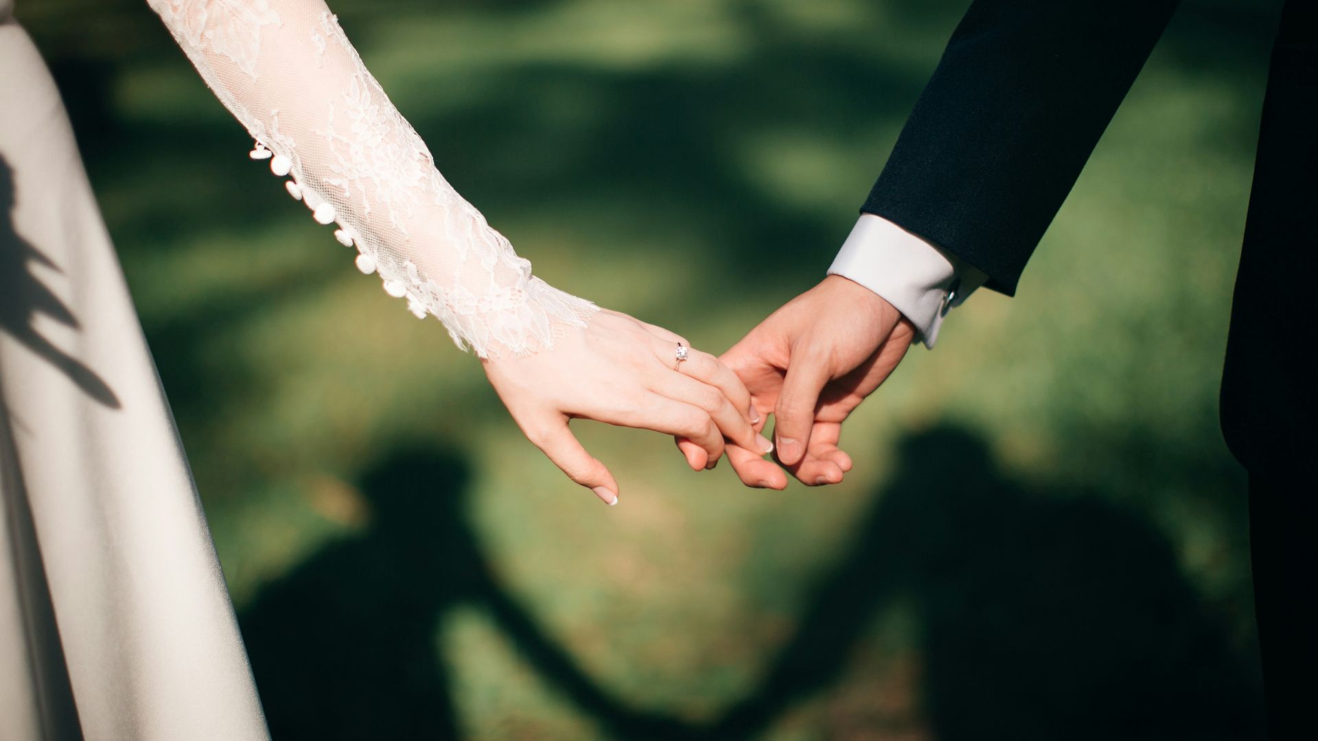 man and woman holding hands focus photo