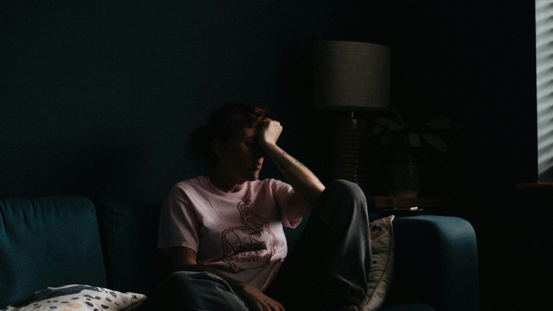 woman in purple dress sitting on couch