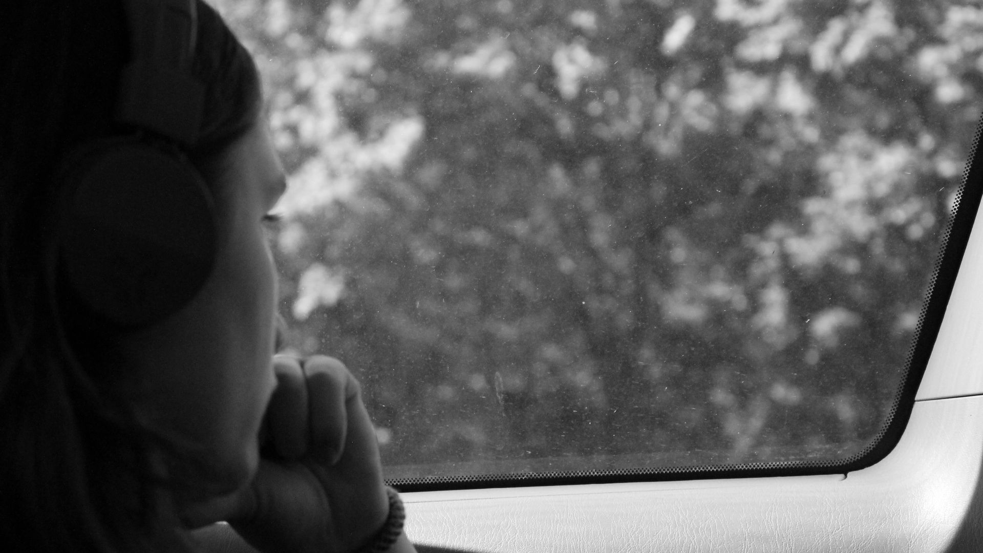 grayscale photo of woman inside car
